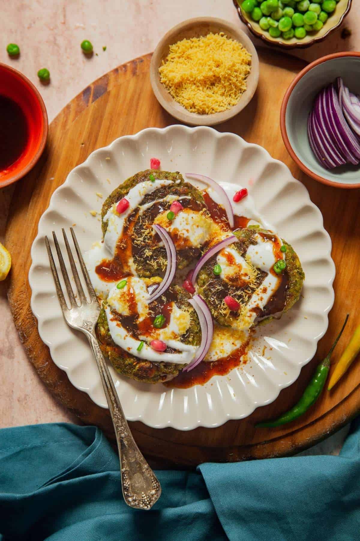 Plate of Matar Paneer Tikki Chaat served with yogurt, chutney, onions and sev. 