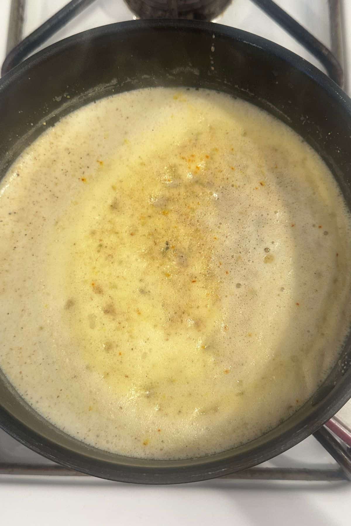 Milk simmering with thandai powder. 