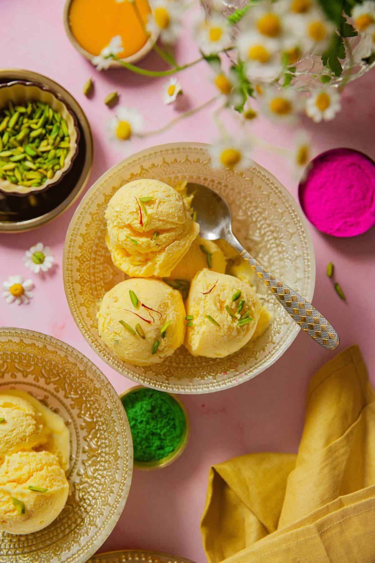 Mango Frozen Yogurt scooped in a yogurt with holi colors