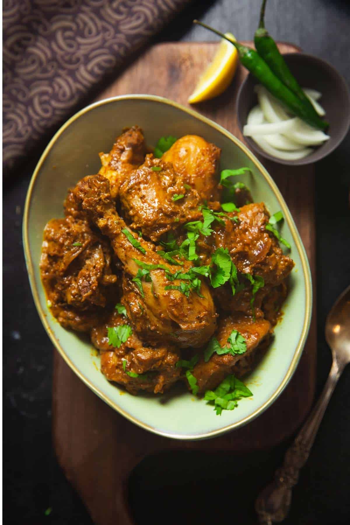 Dahi Chicken in a sage colored bowl close up