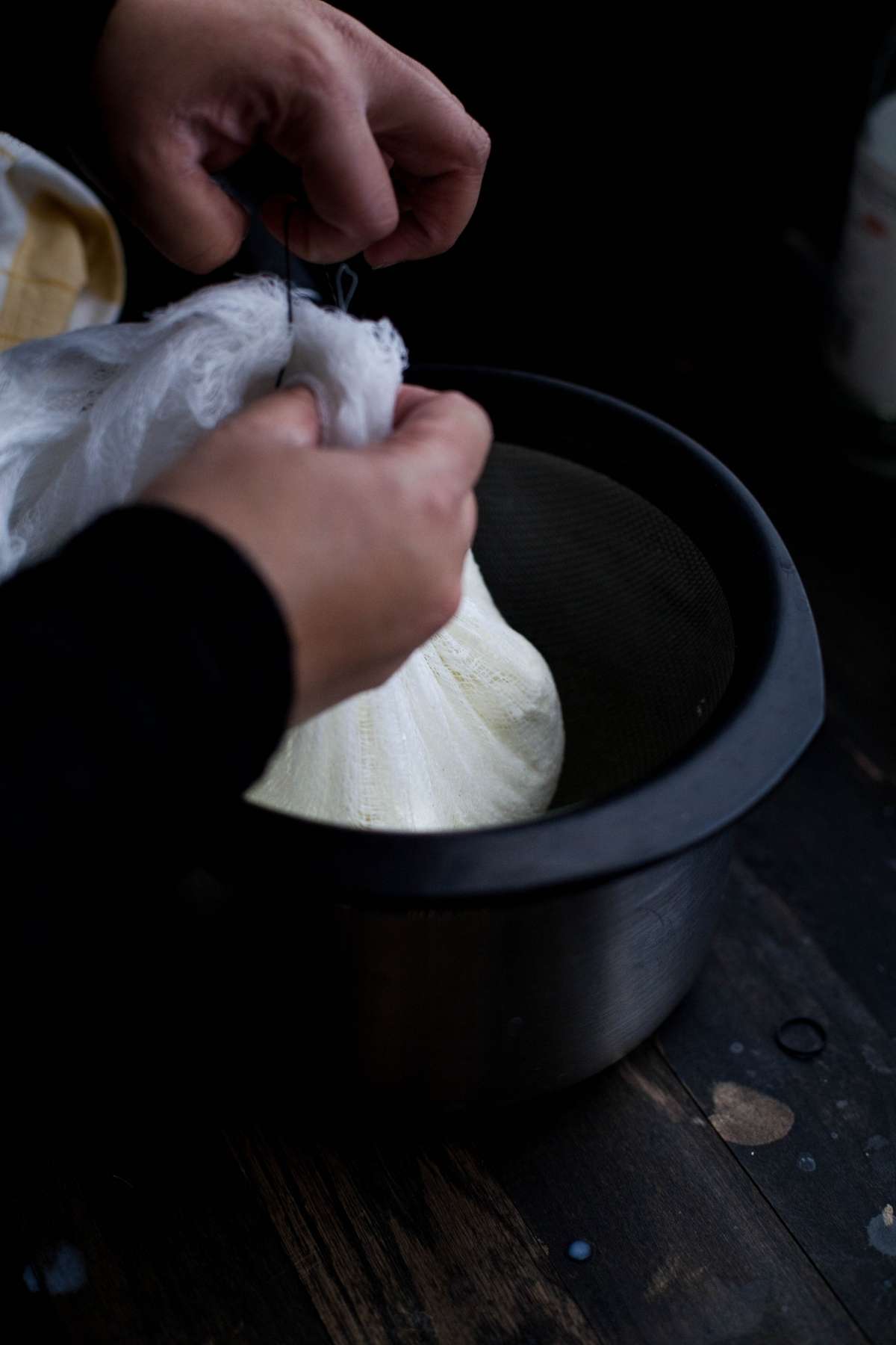 Tying paneer curds in a cheesecloth