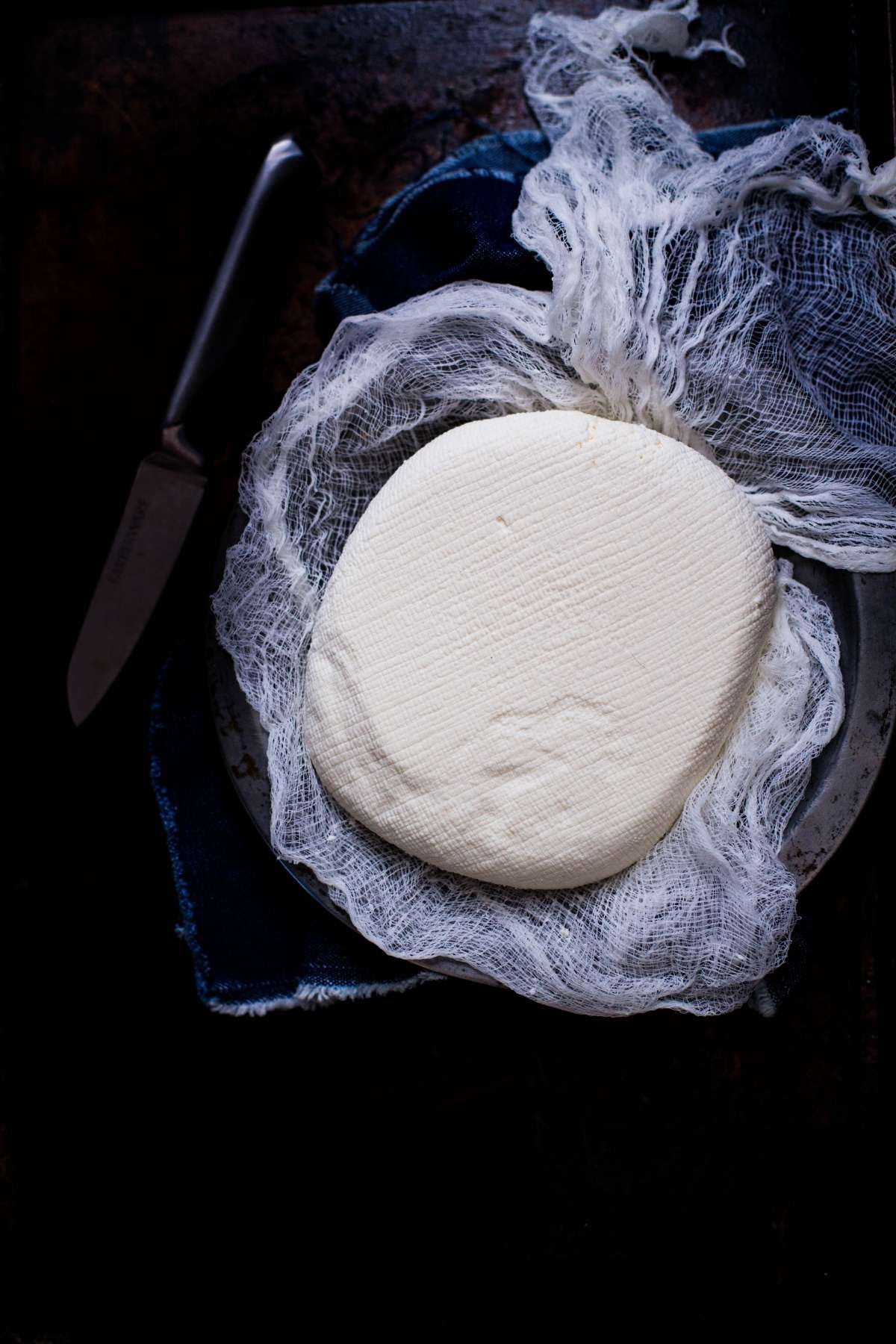 Block of Paneer wrapped in cheesecloth