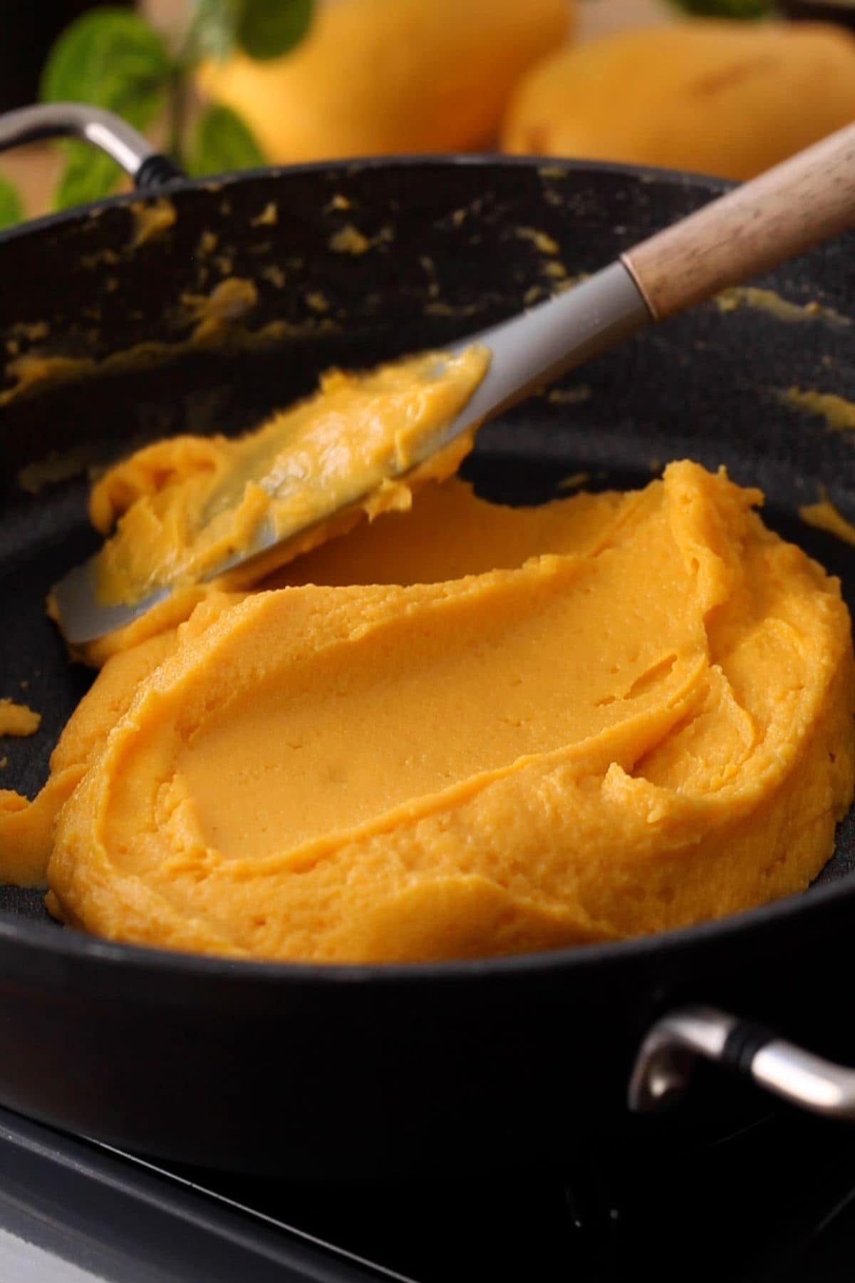 Burfi mixture starts getting runny as sugar melts.