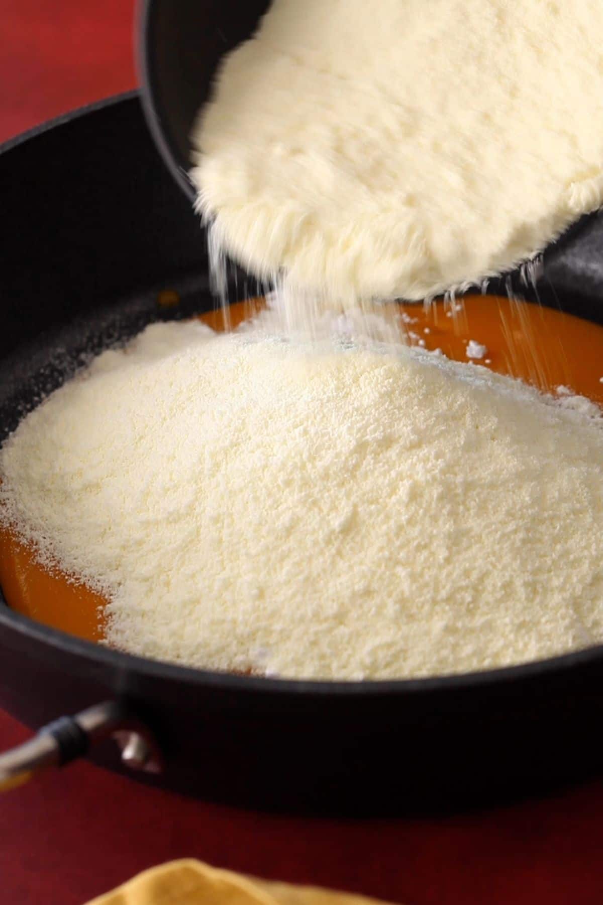 Milk powder is added to the pan.