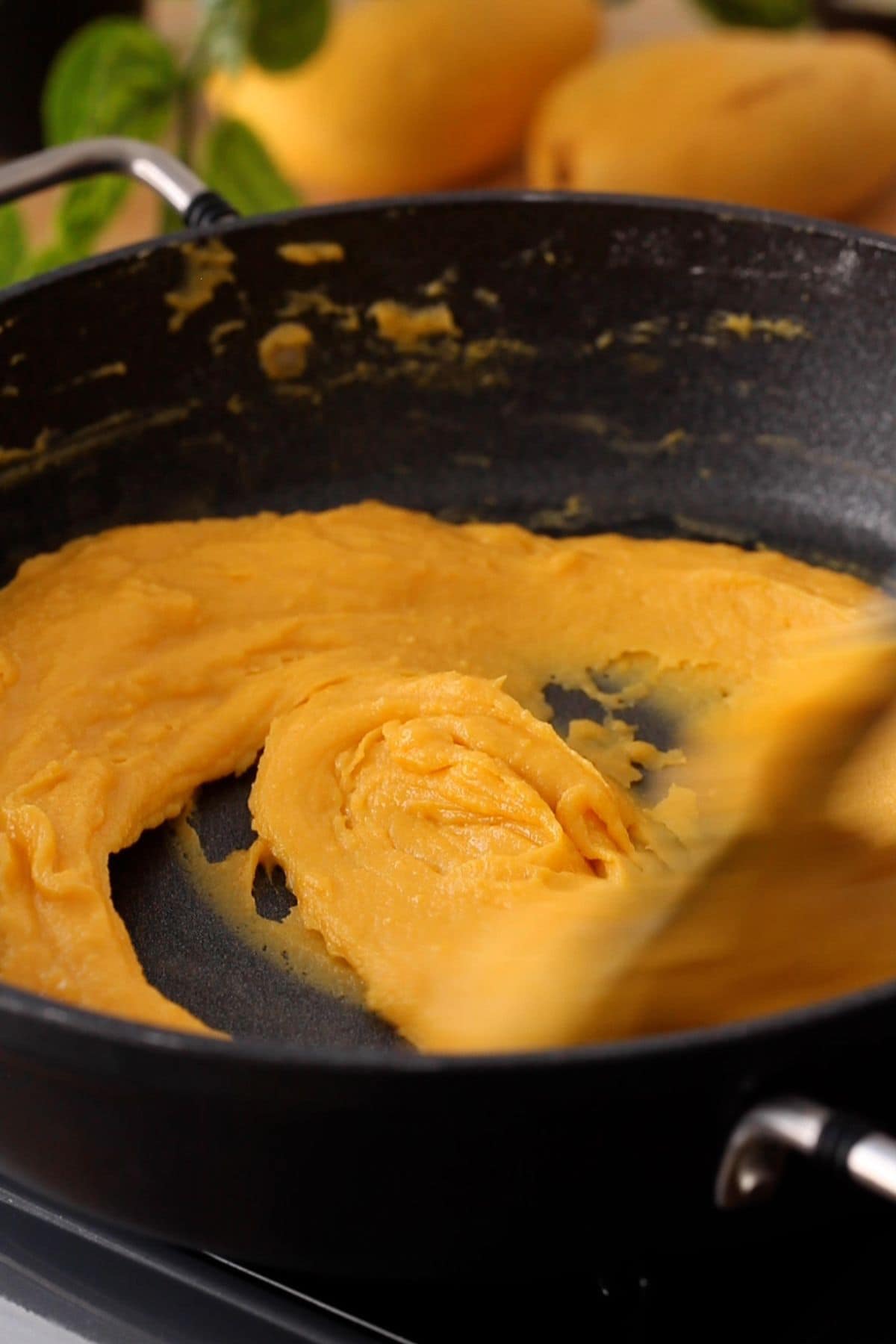 Cooking mango burfi mixture on low heat.
