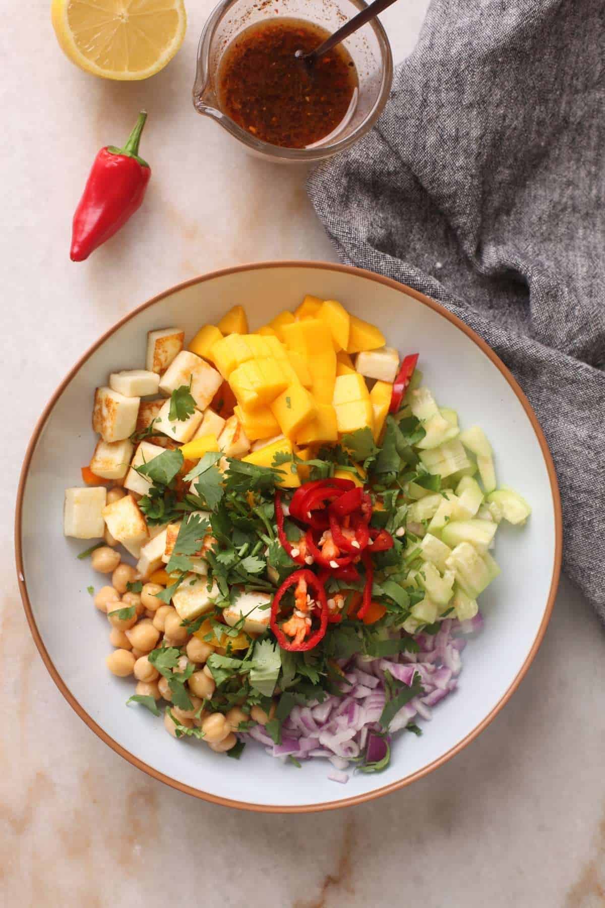 Chopped indian fresh cheese salad ingredients in a bowl ready to be tossed with dressing, 