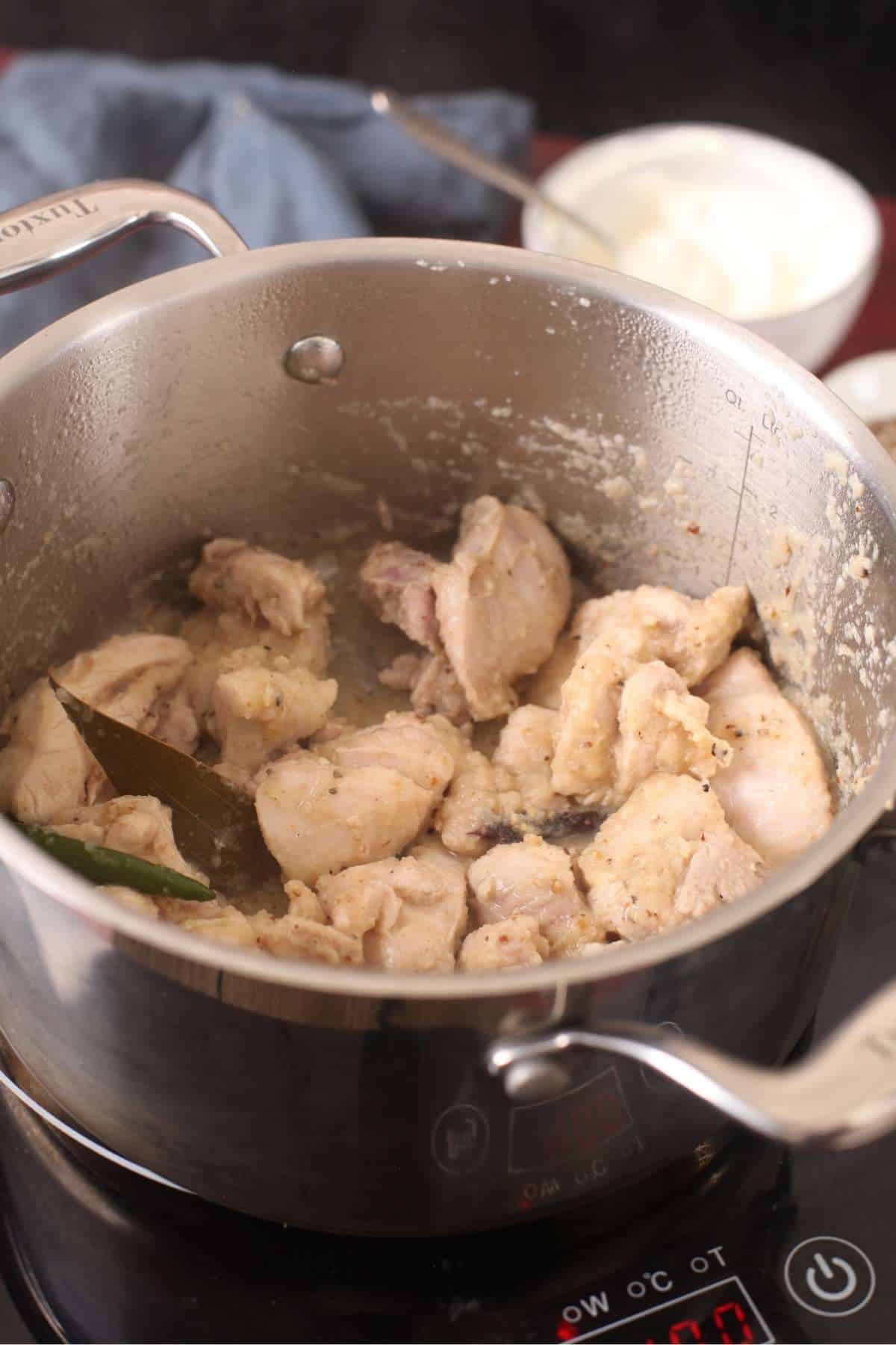 Chicken is seared in onion and spices.