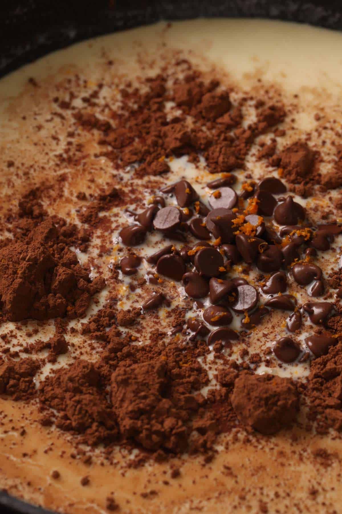 Chocolate Chips, Cocoa powder and orange zest added to thickened milk. 