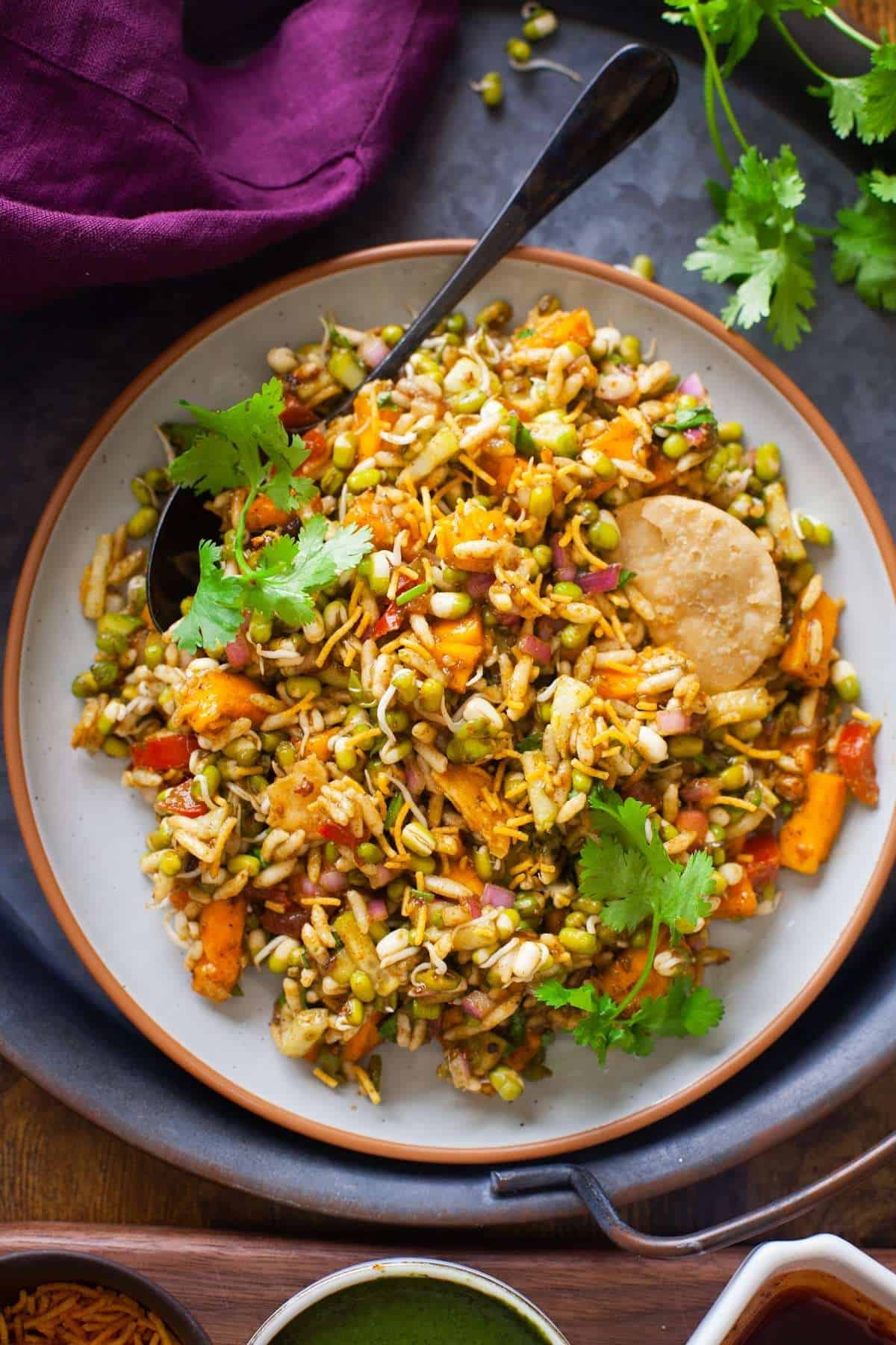 Sprouted Green Moong Chaat in a grey ceramic plate.