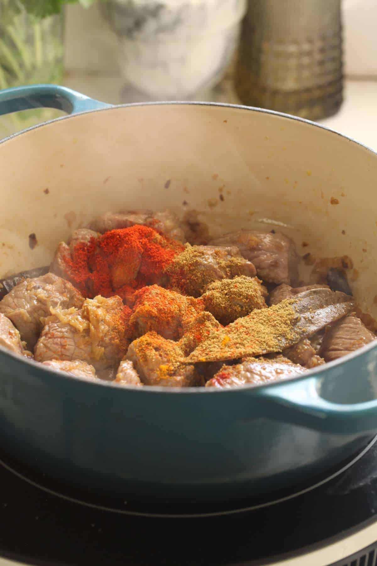 Powdered spices added to lamb.