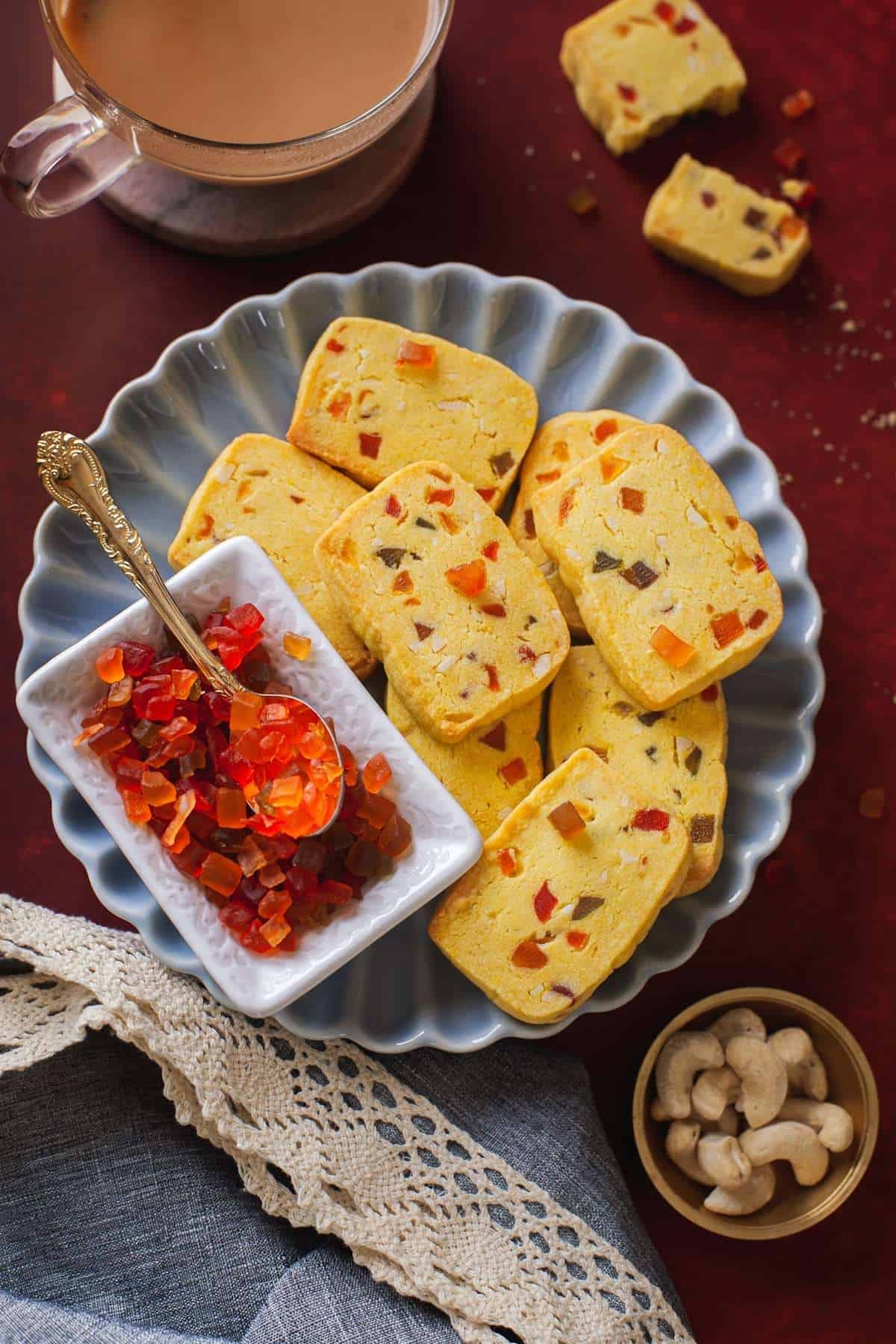 Tutti Frutti Biscuits in a fluted blue plate with chai.