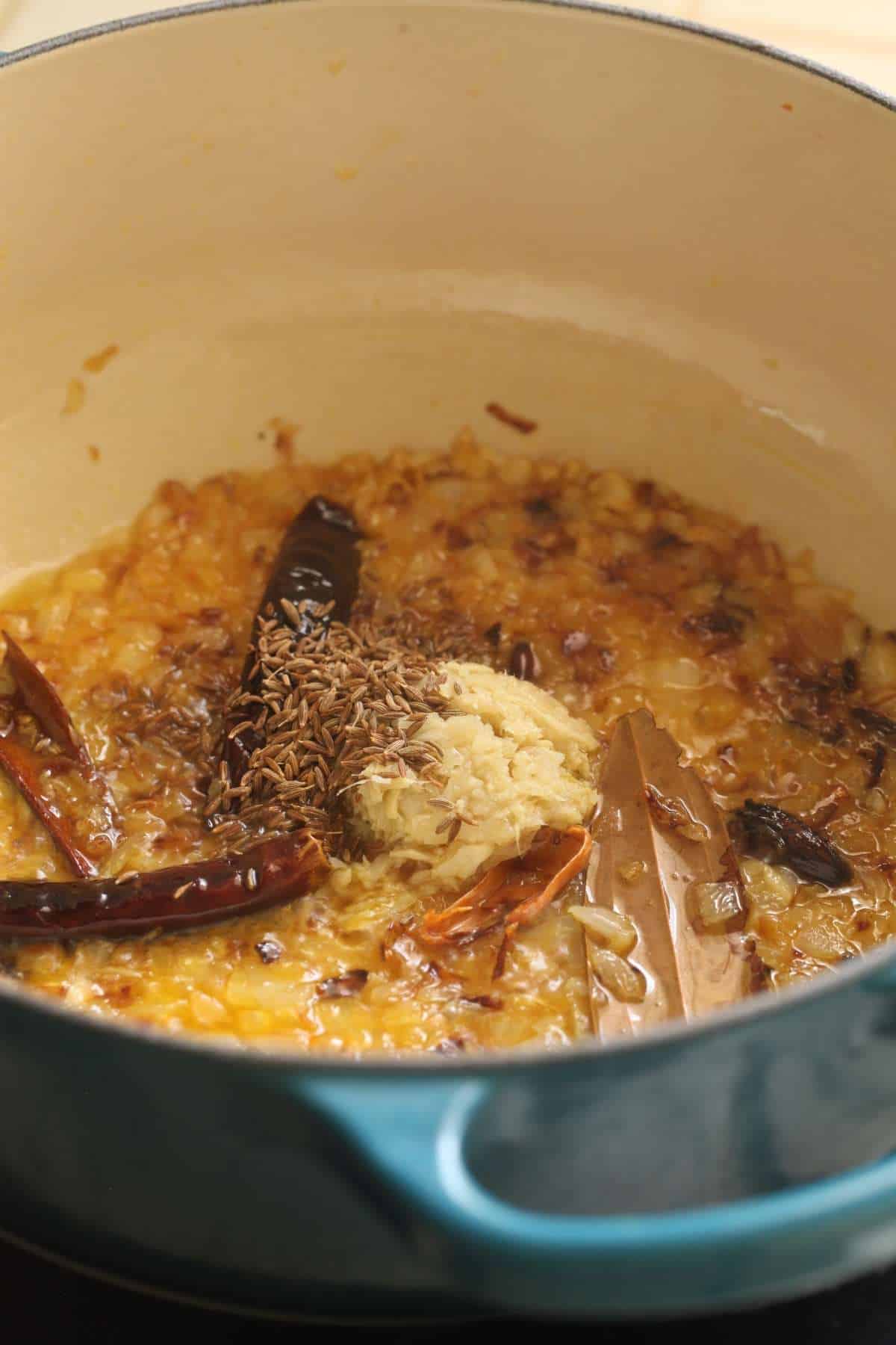 Add ginger garlic and cumin to onions.