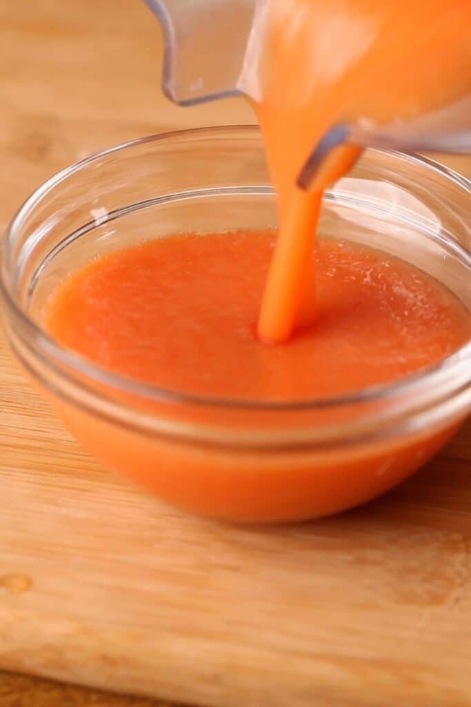 Puree blanched tomatoes in a blender.