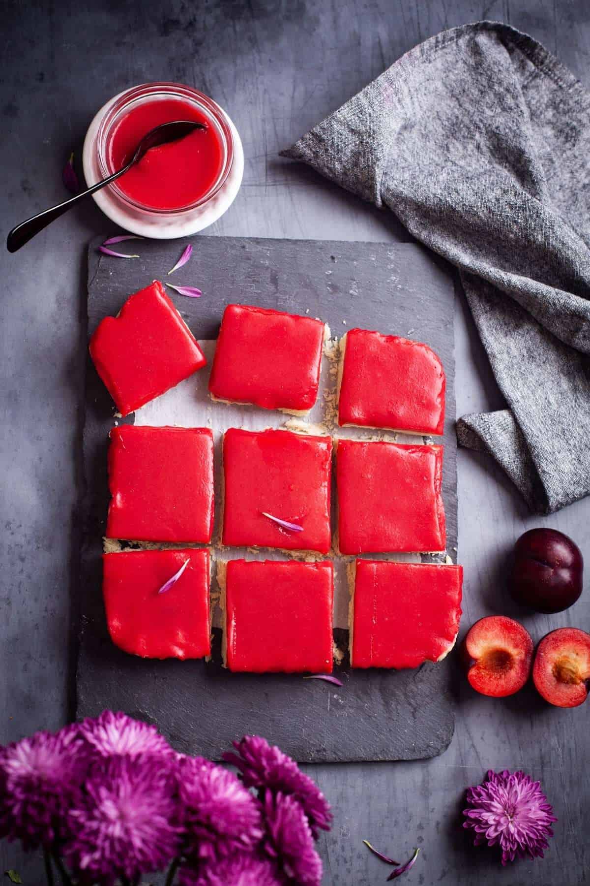 Ginger Plum Bar Squares on a Slate Board with fresh plums