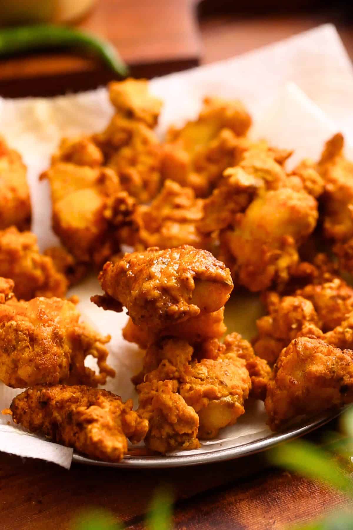 Fish pakoras drained on paper towel. 
