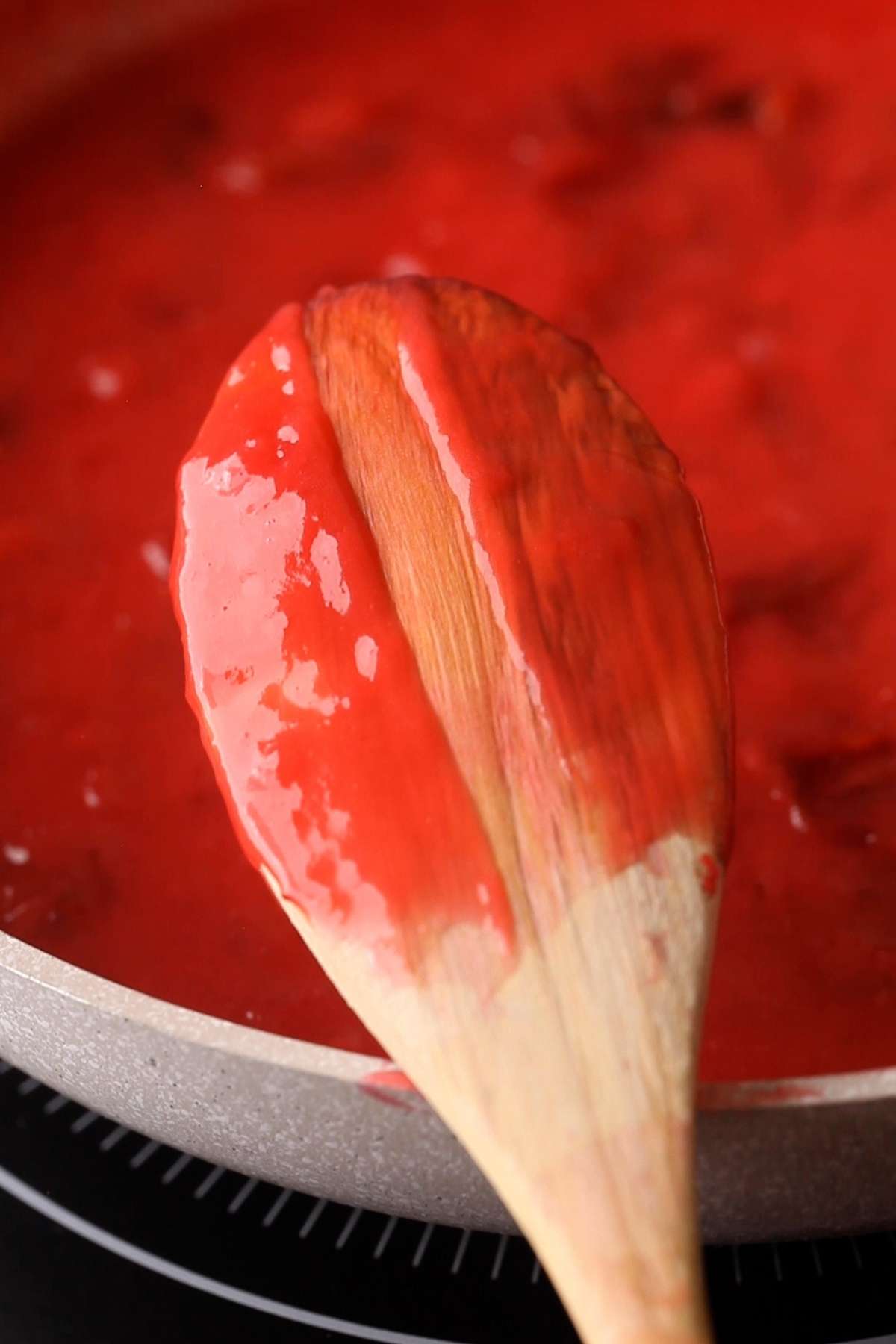Plum Filling consistency check by seeing if it's Coating the back of spoon. 