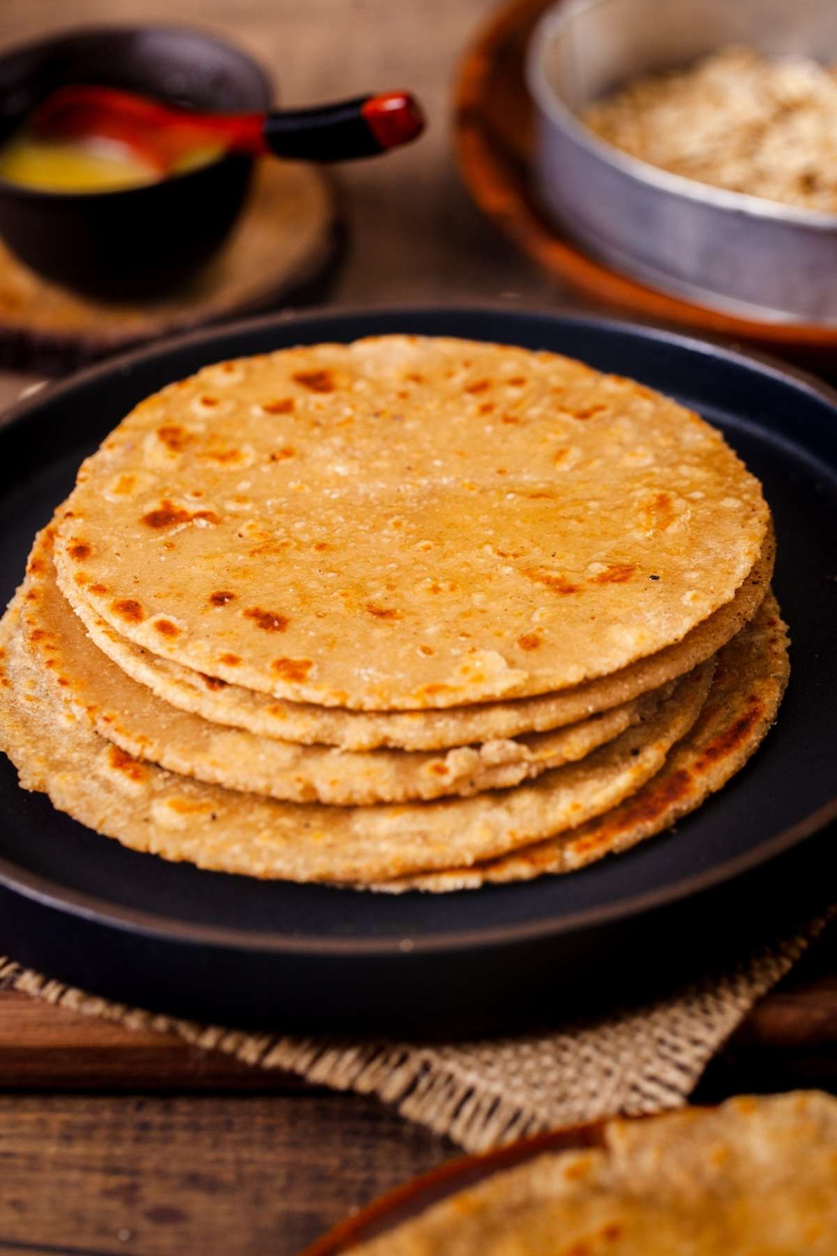Stack of Oats Roti on a black plate.