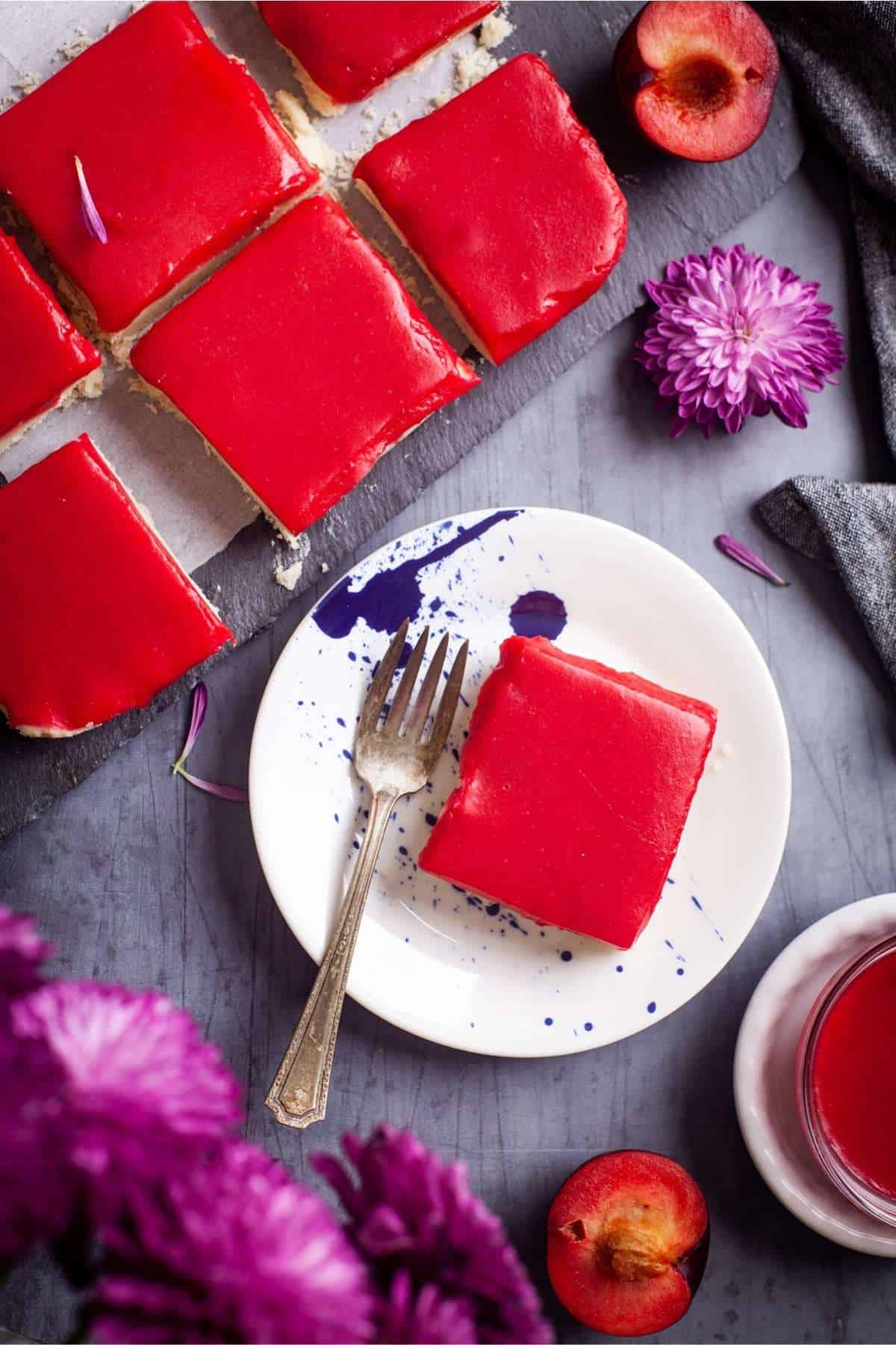 Ginger Cardamom Plum Bar Square on a blue plate with fork. 