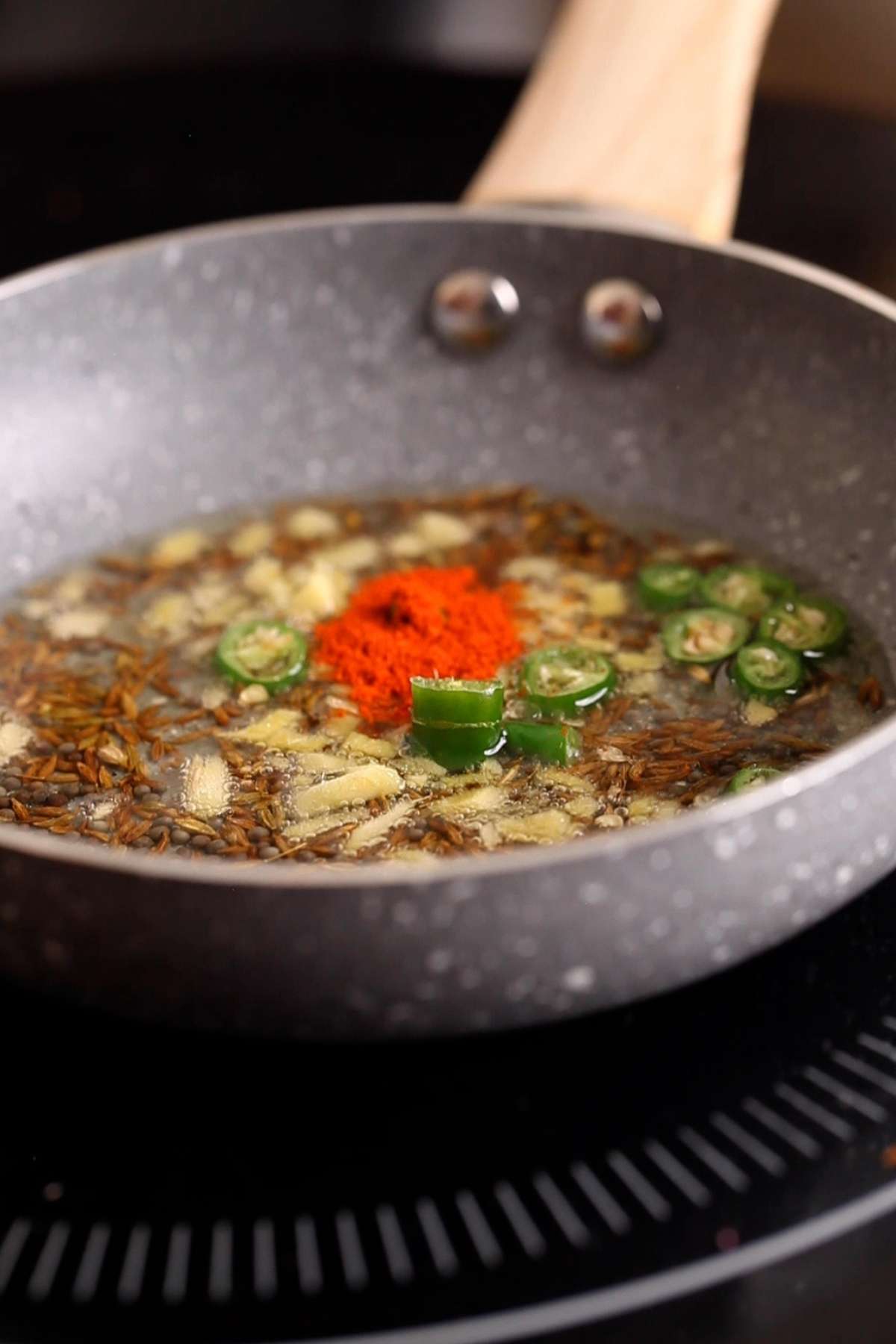 Make the tempering with whole spices crackled in hot oil. 