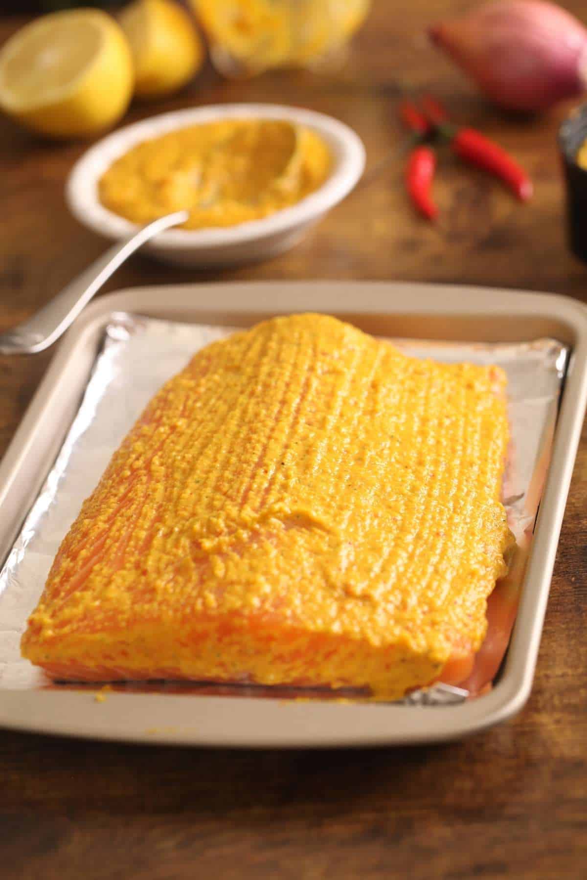 Fresh spice slathered on salmon and ready for baking.