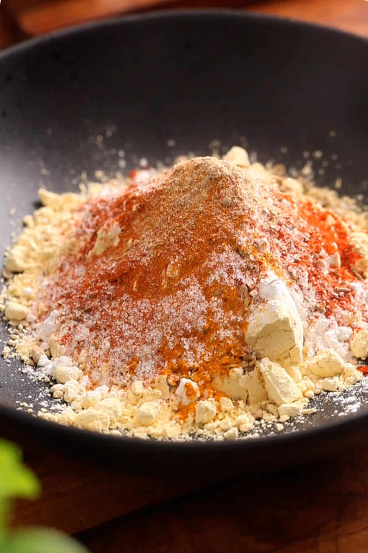 Spices are added to the gram flour and rice flour. 