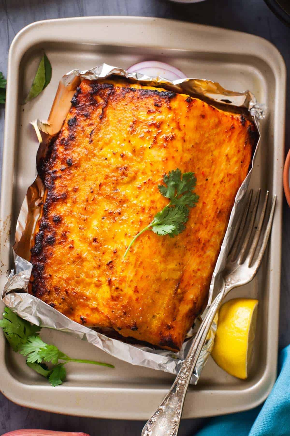 Salmon out of the oven with charred bits.