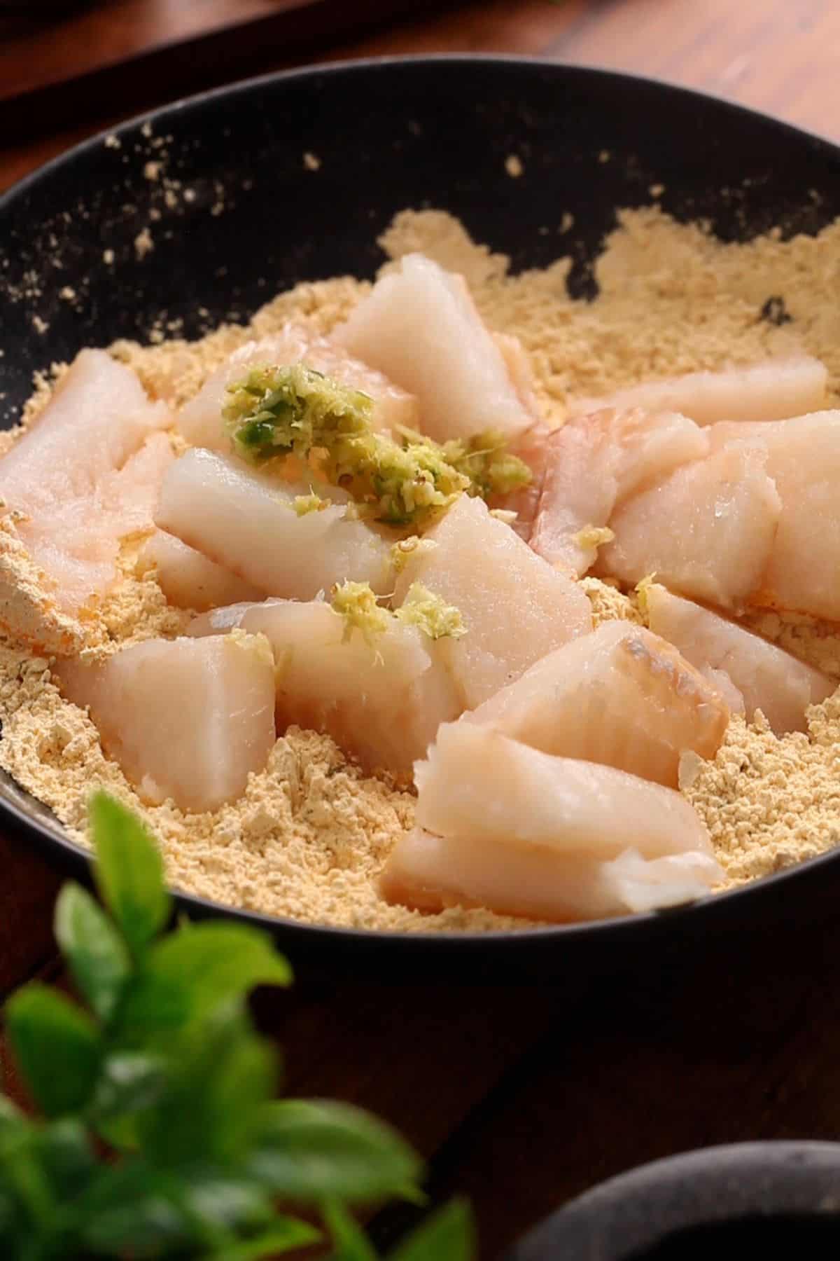 Fish is added to the dry flour mixture.