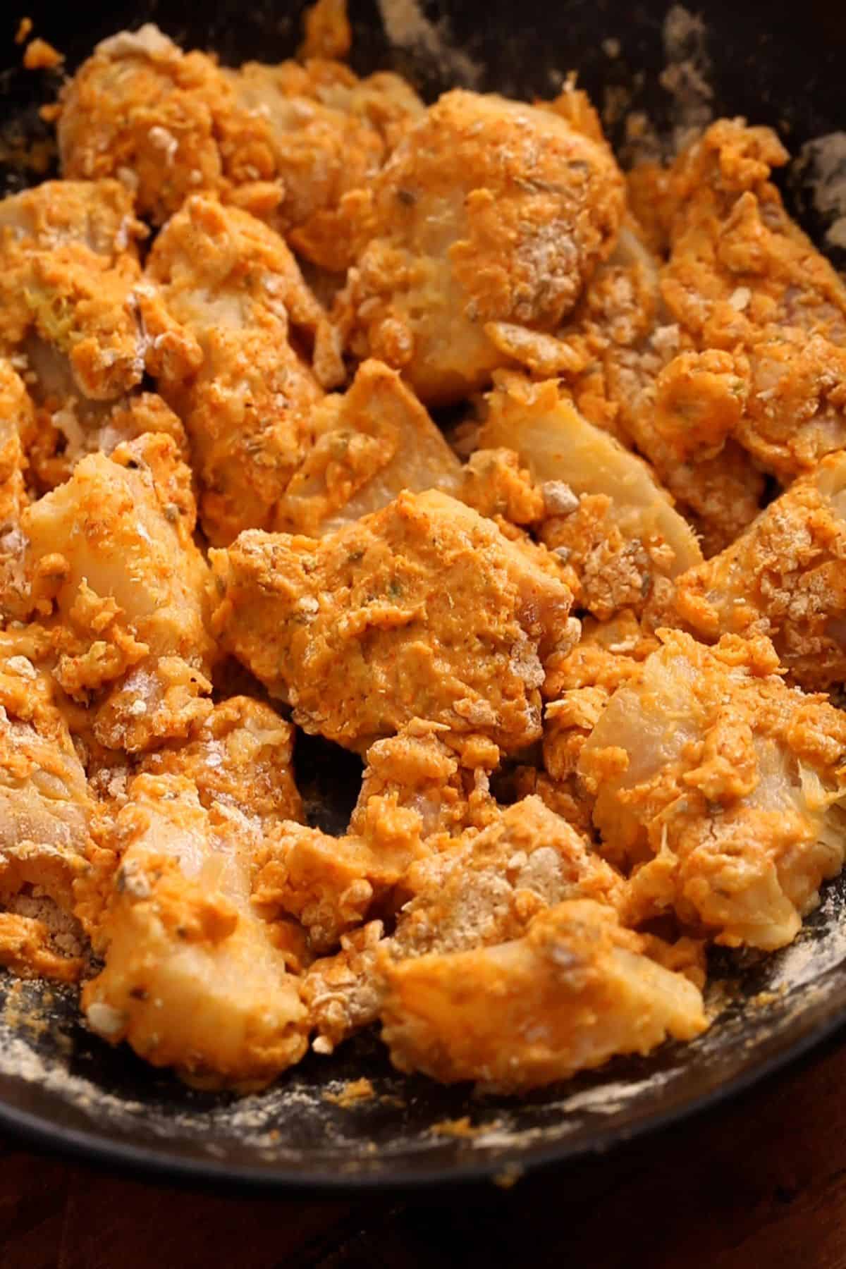 Fish is coated in the spiced flour mixture. 