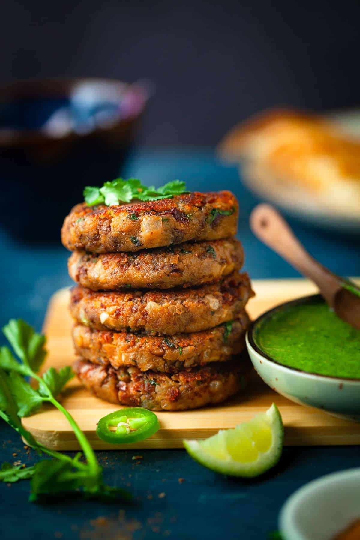 Stack of Rajma Kebab with lime and cilantro.