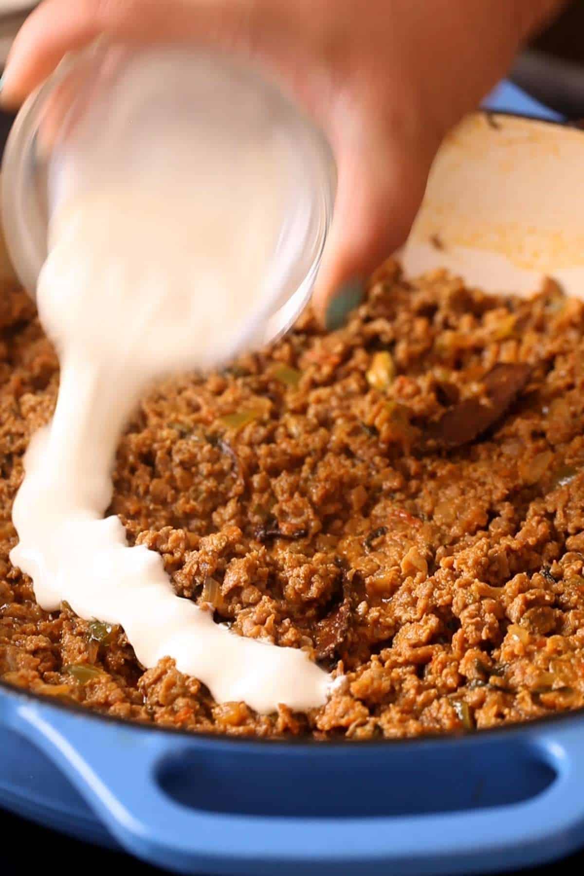 Finishing the keema with heavy cream and yogurt. 