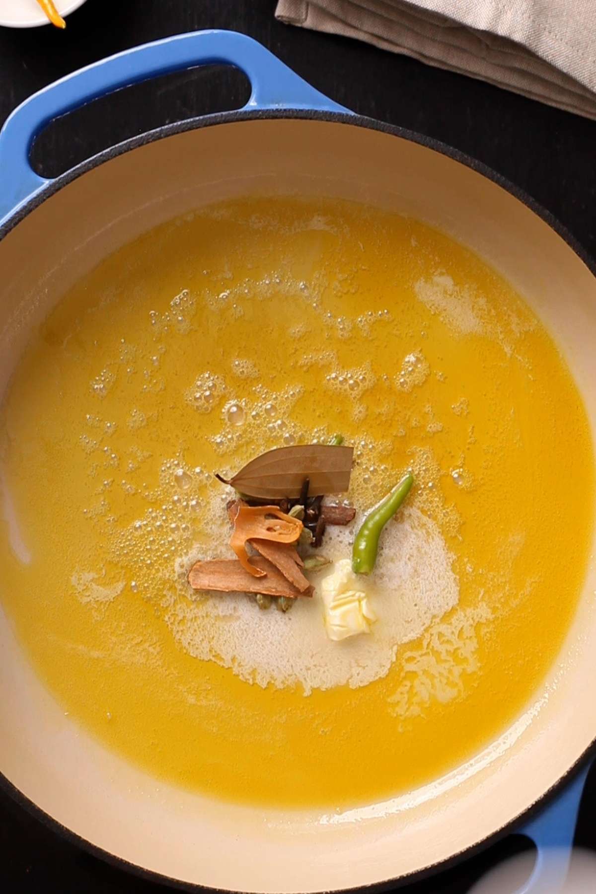 Whole spices and chillies in oil & butter.