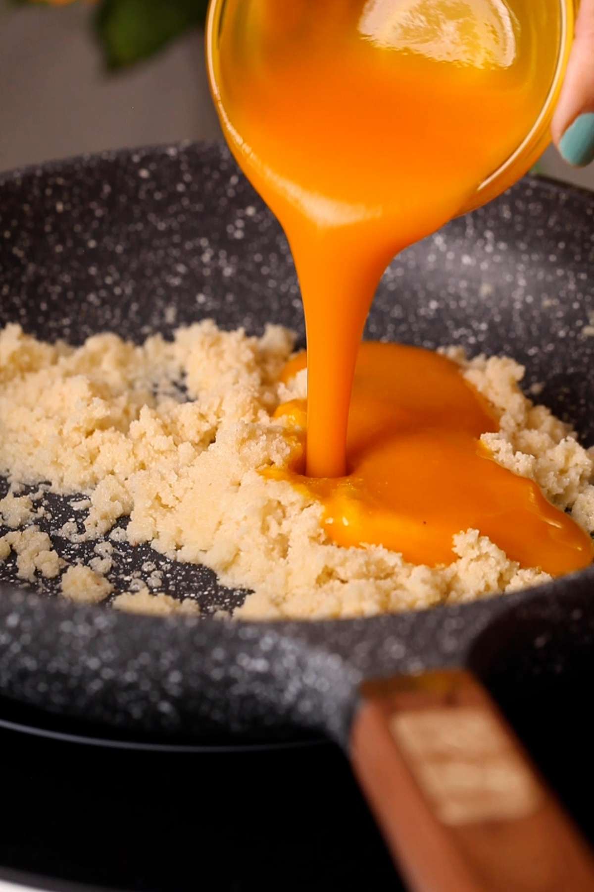 Mango pulp being added.