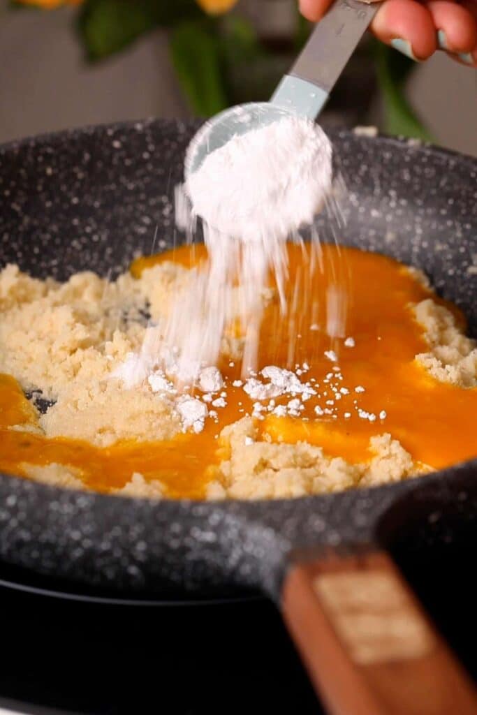 Adding powdered sugar.