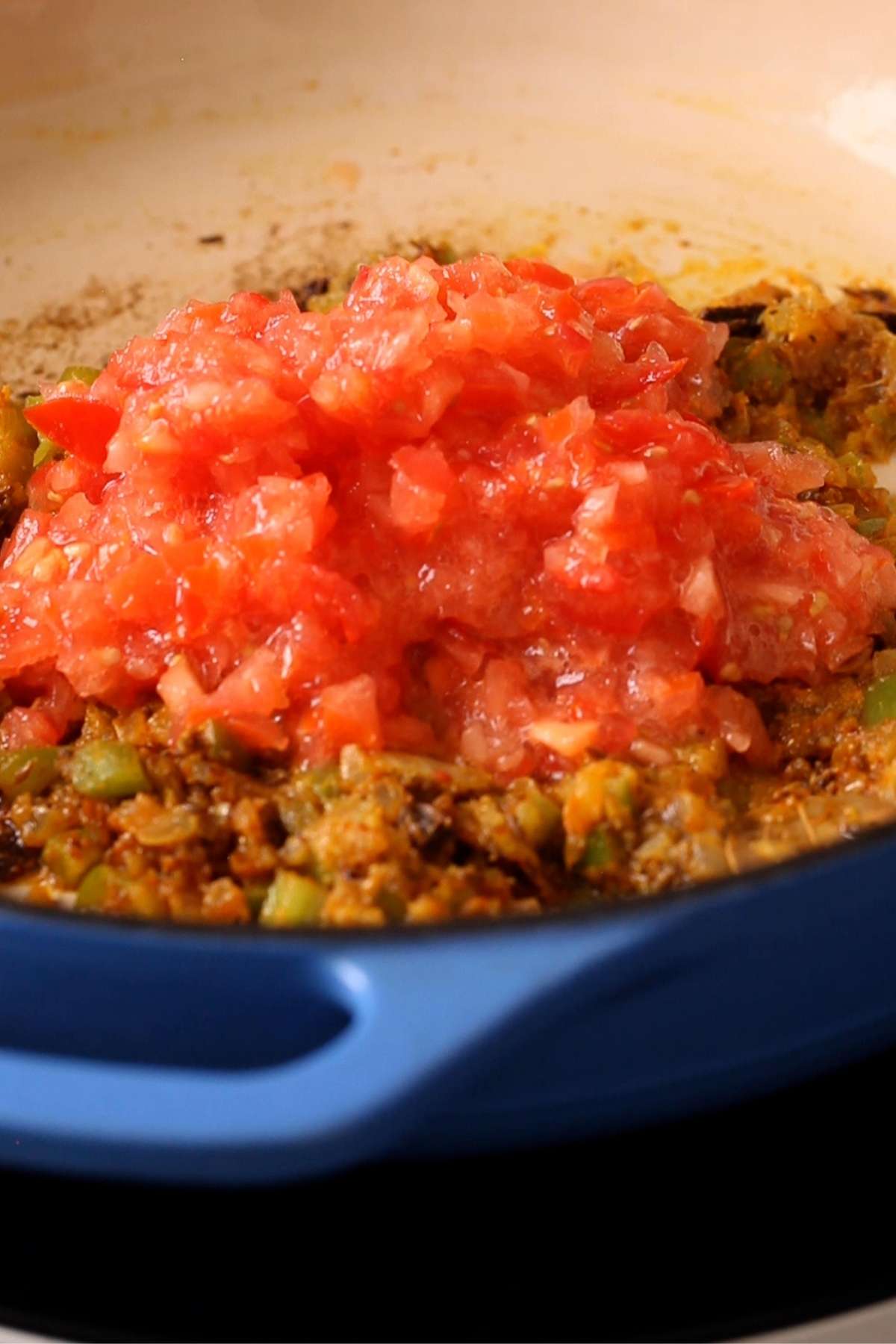 Finely chopped tomatoes added to masala. 