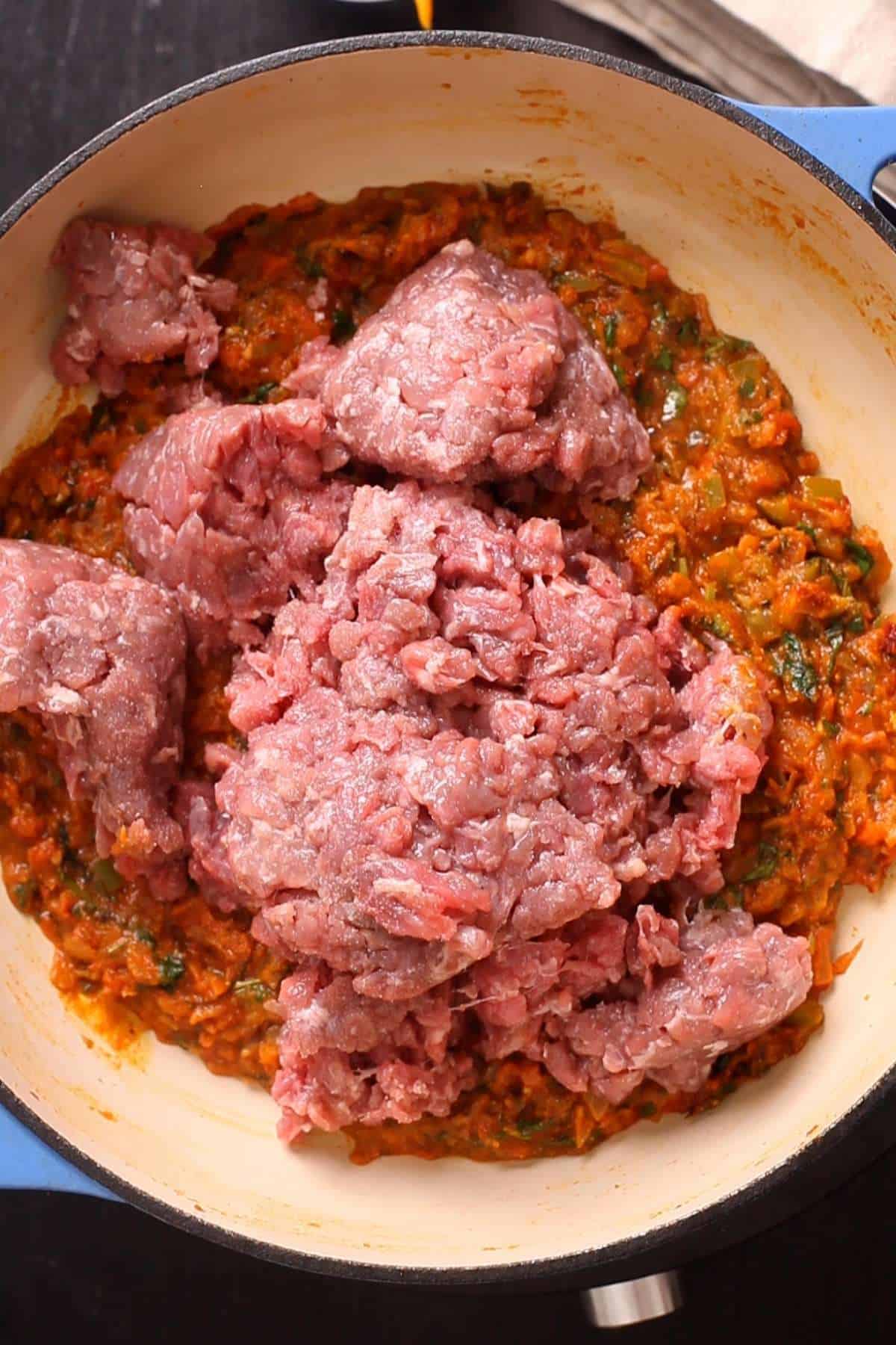 Minced goat is added to the masala base. 