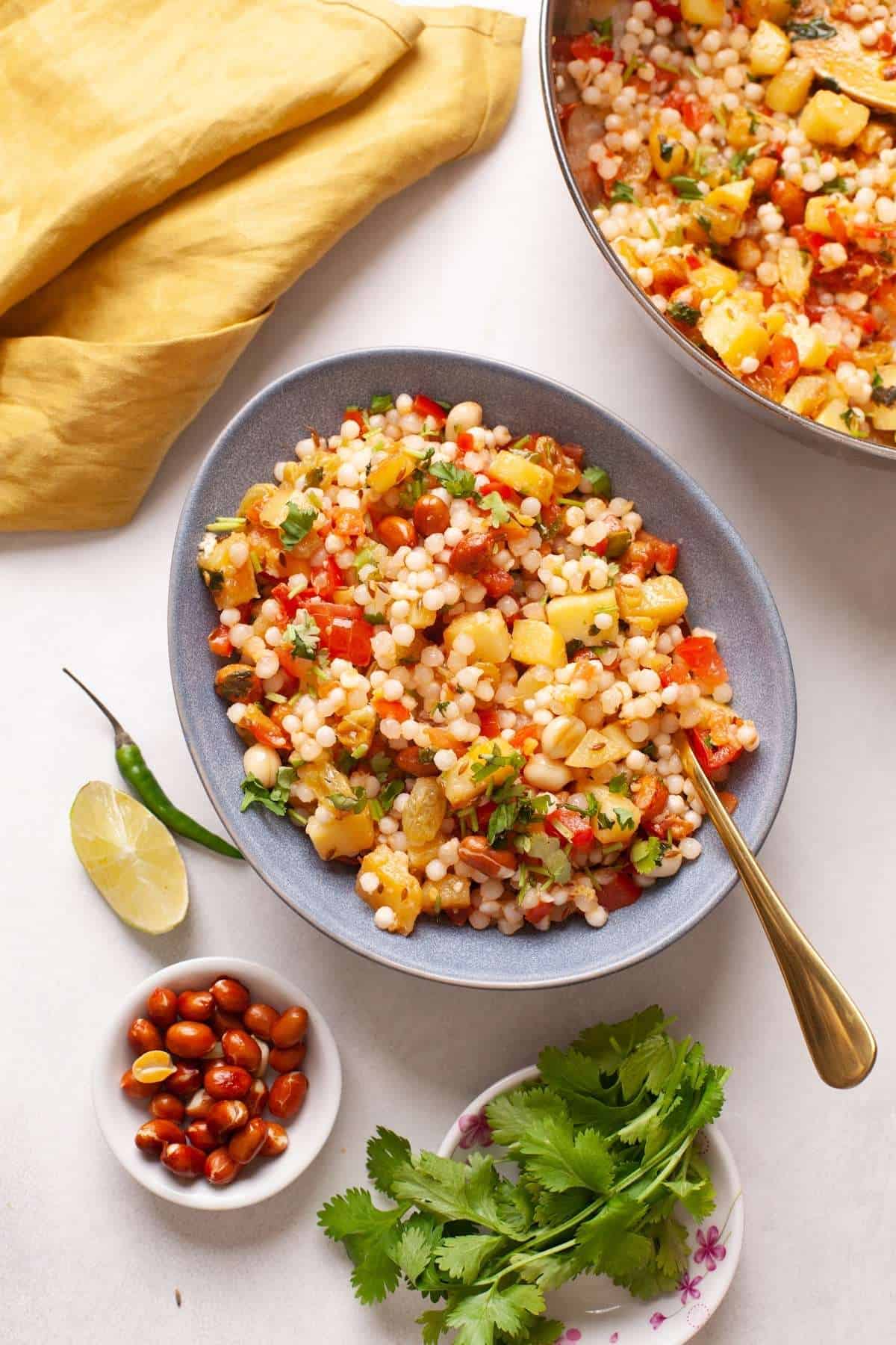 Sabudana Khichdi in a blue bowl on a marble background. 