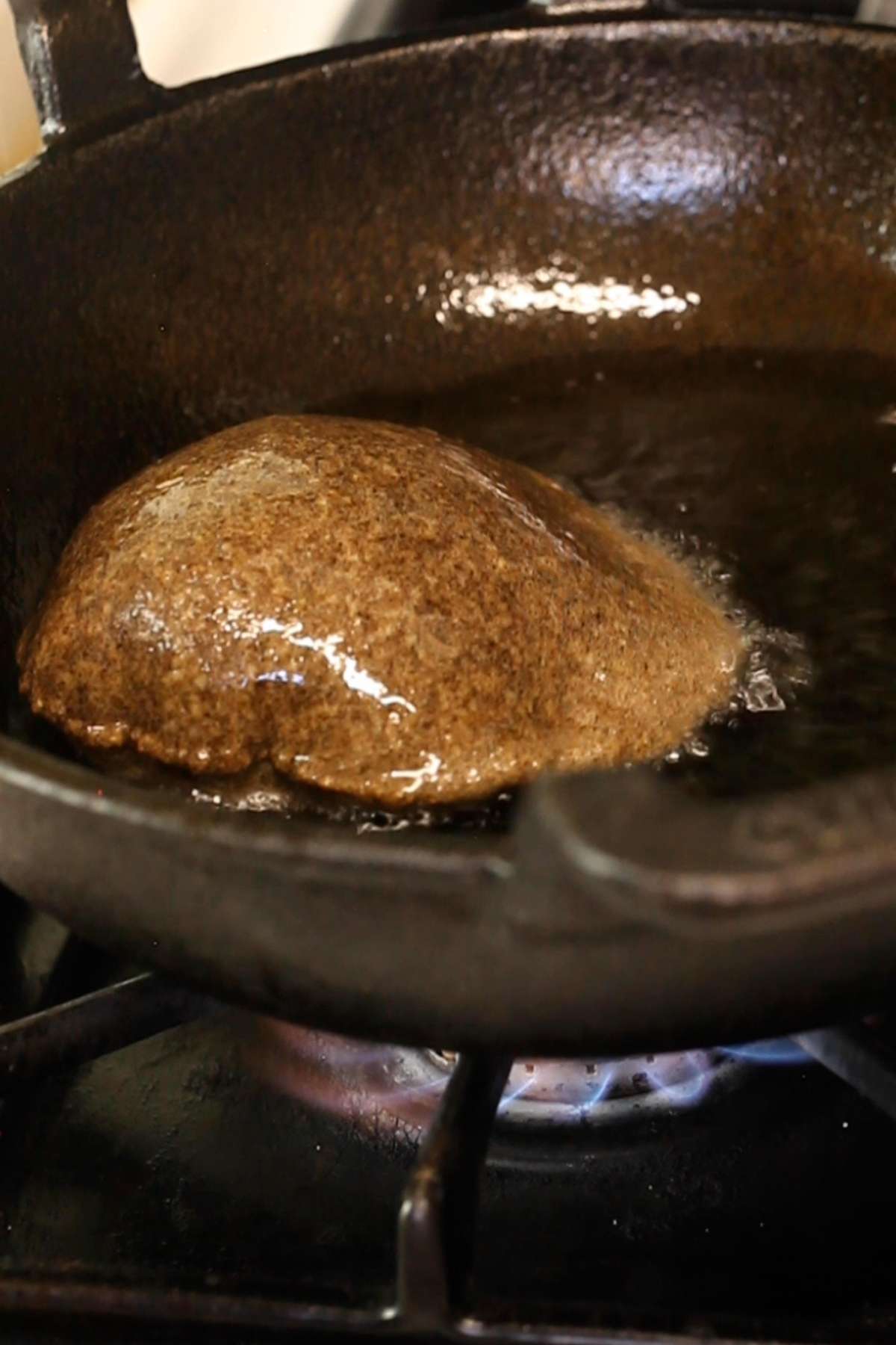 Puffed kuttu poori in hot oil.