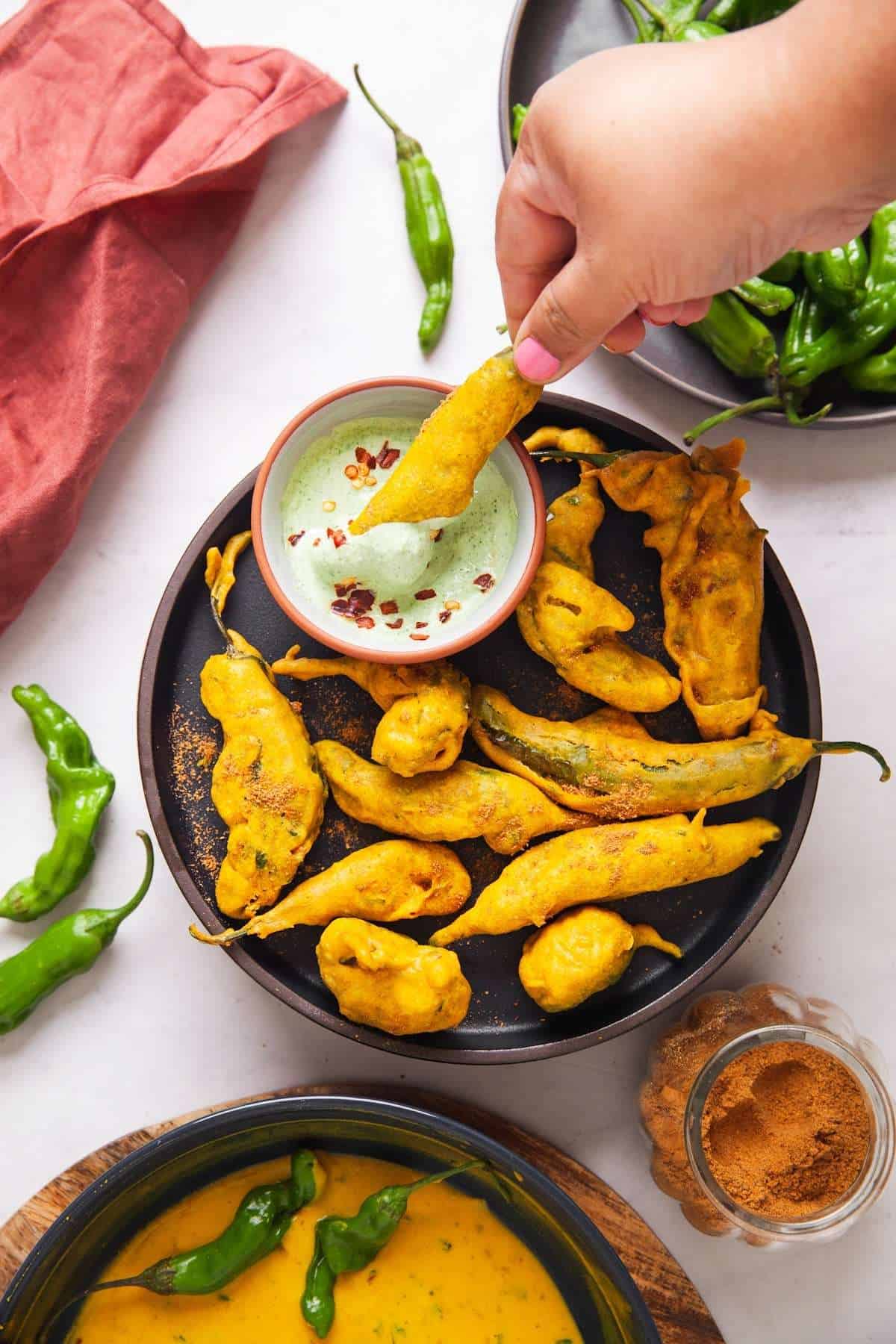 Dipping Shishito Fritter in yogurt dip. 