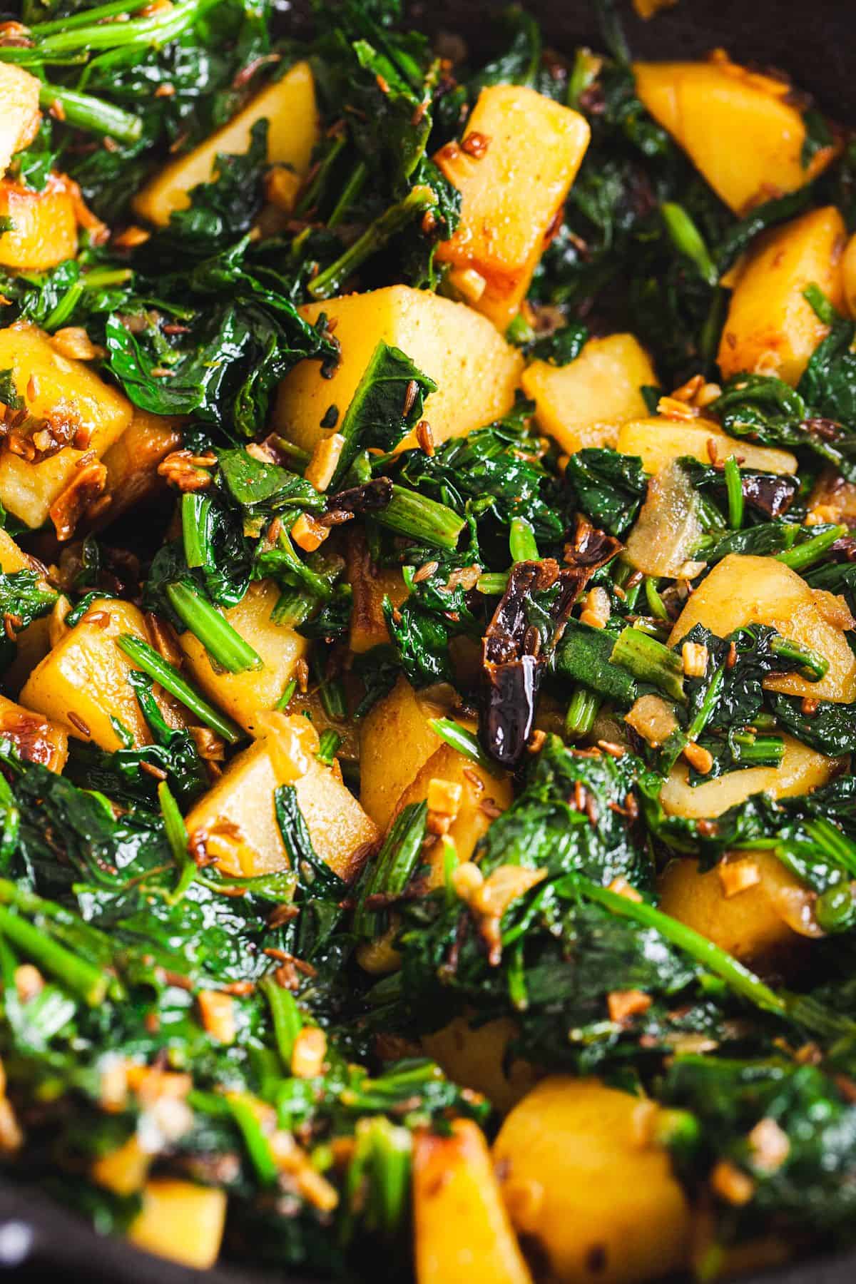 Close up image of cooked indian style spinach and potatoes.