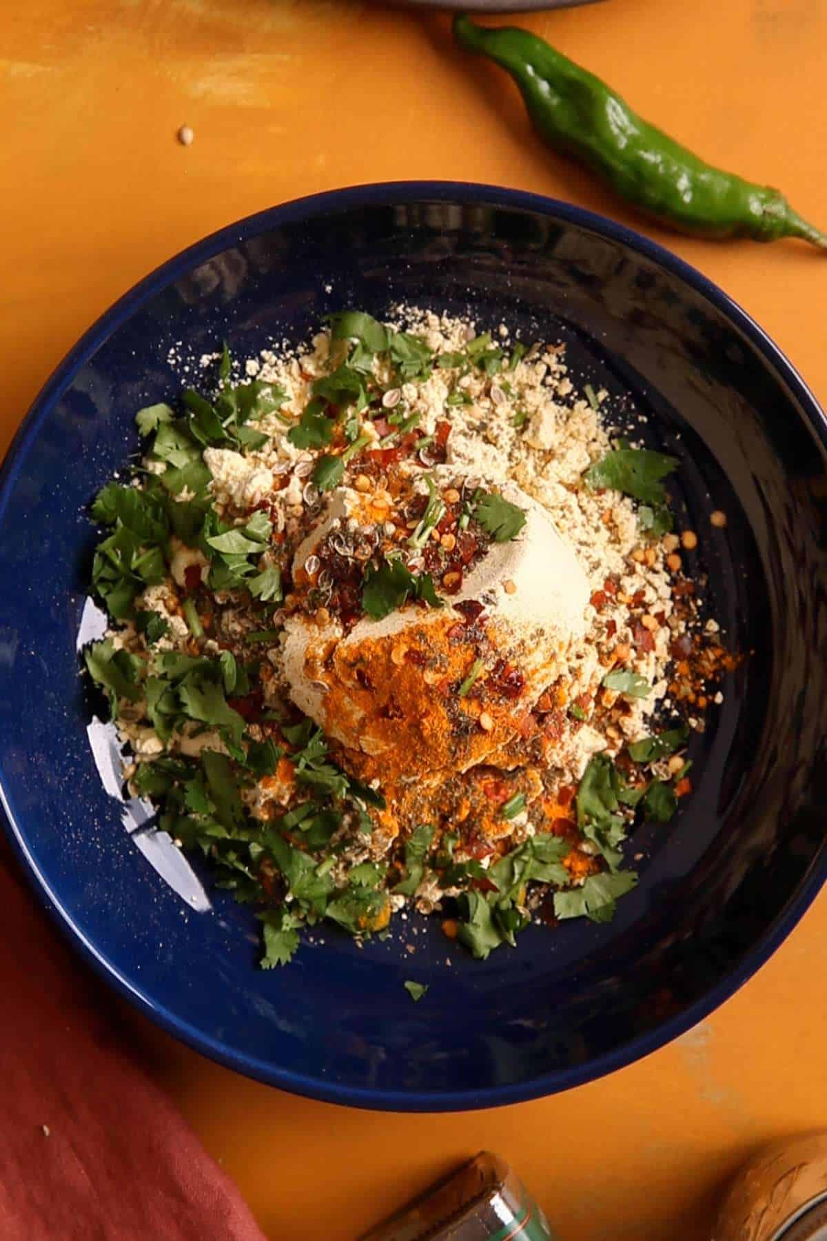 Gram Flour & Rice flour with fresh spices and herbs in a blue plate. 