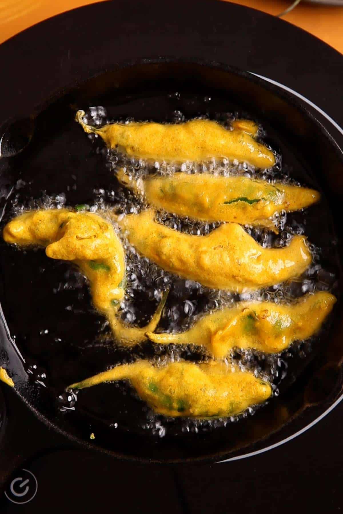 Deep frying pepper pakora. 
