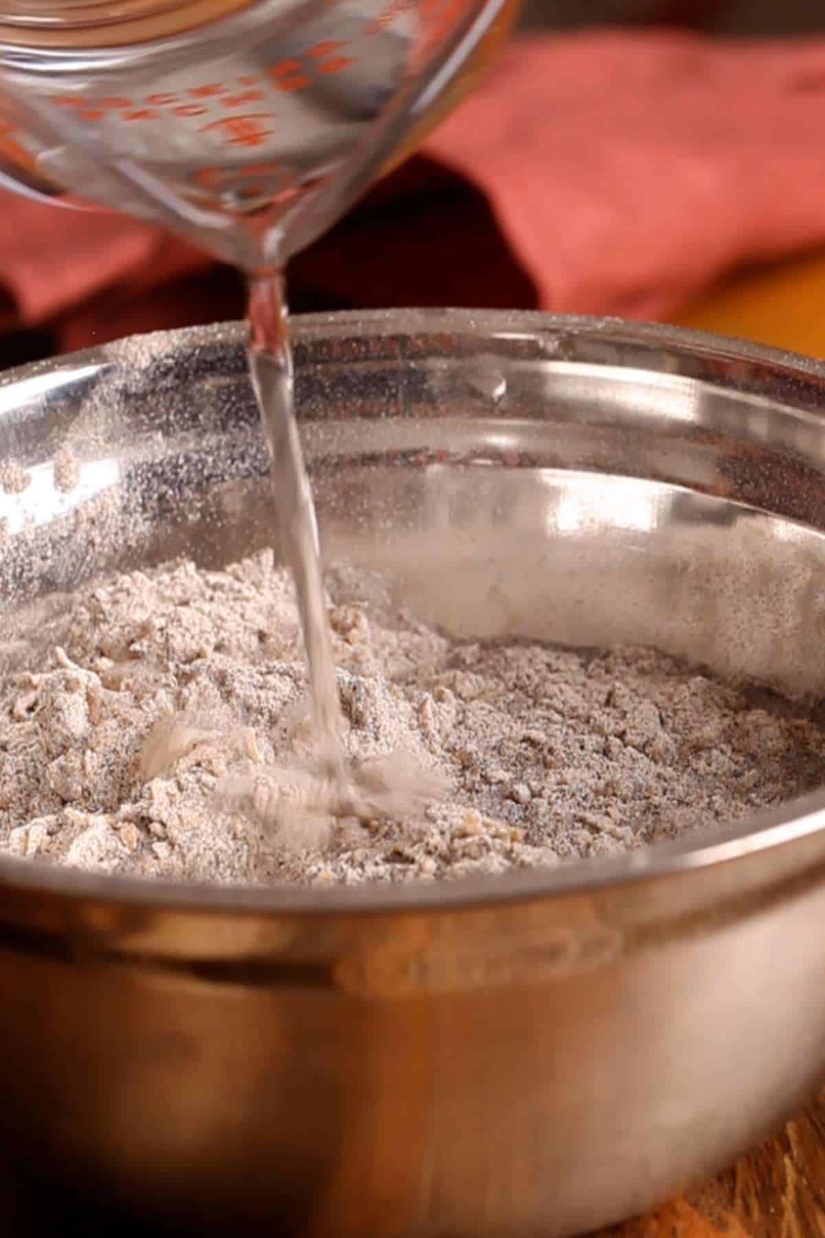 Adding water to make dough.