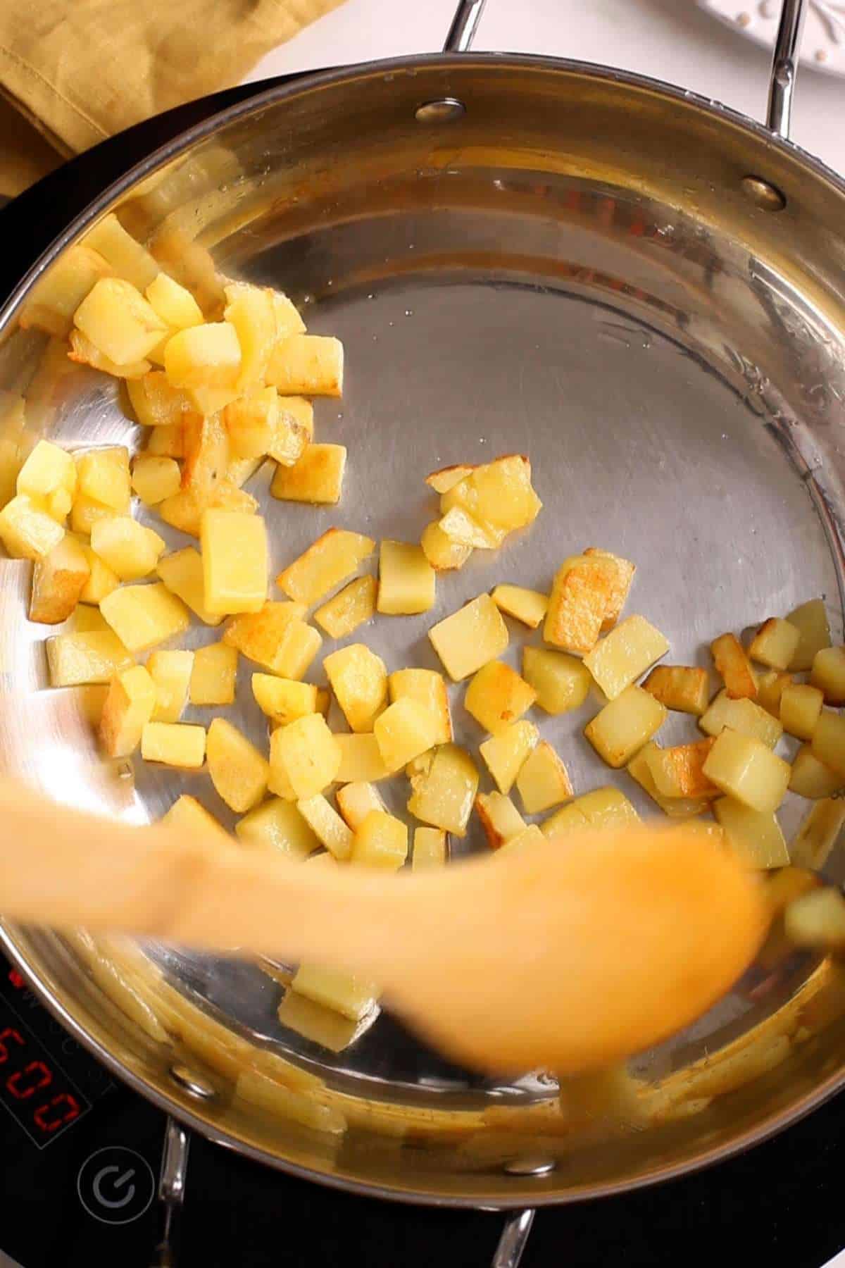 Crisping potatoes in ghee.