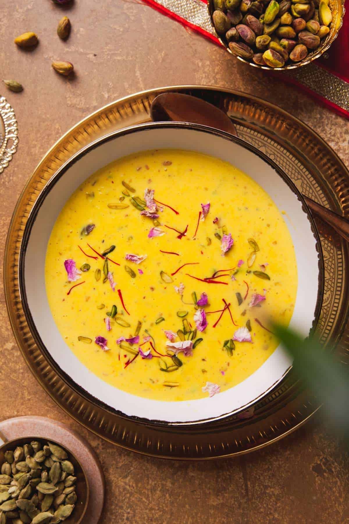 Easy Instant Rabdi in a white and gold bowl placed over a gold plate.
