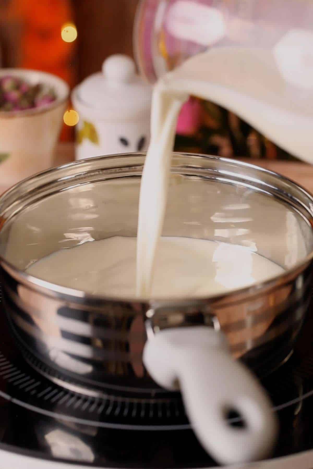 Pouring Milk in a pot to reduce.