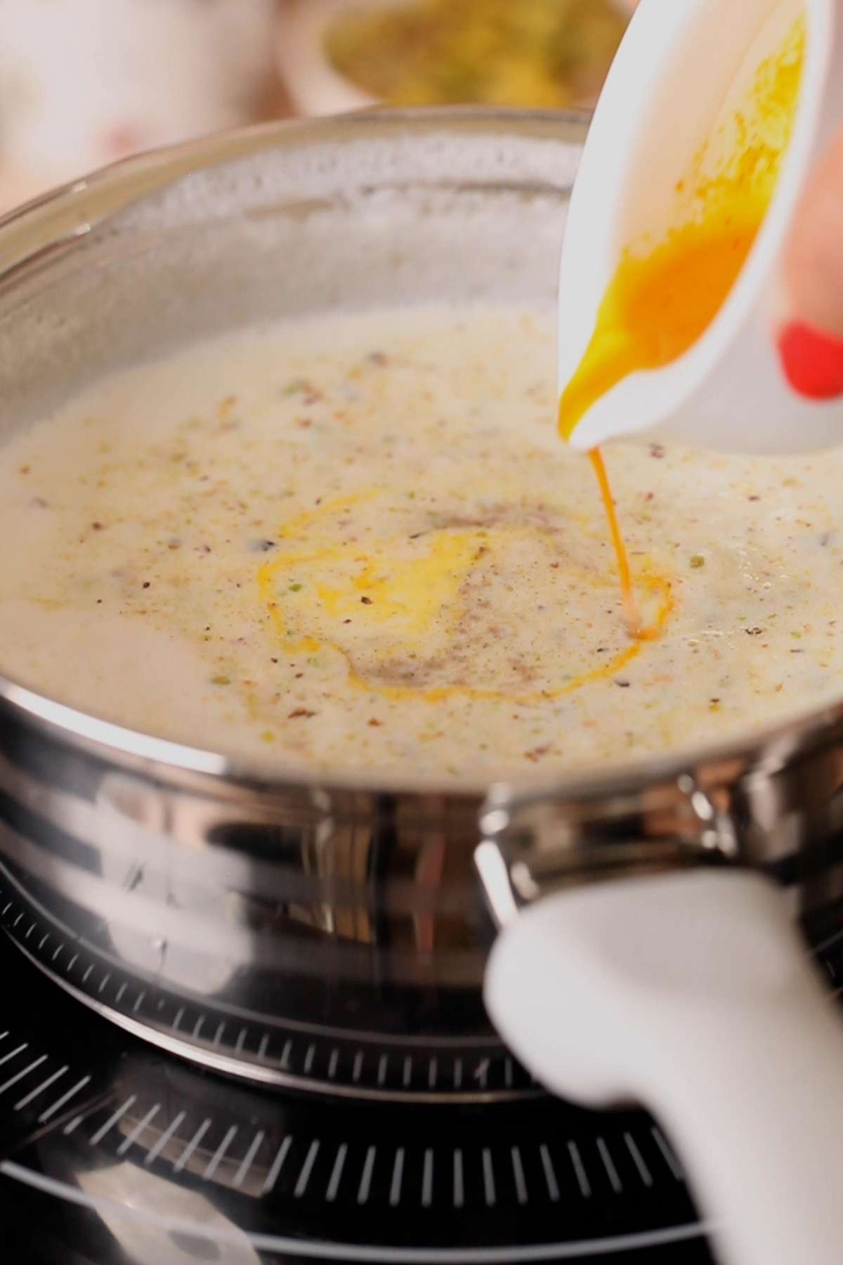 Add nuts, saffron to reduced milk.