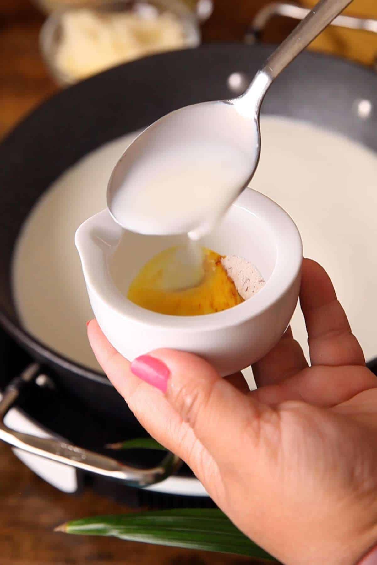 Soaking saffron threads in water milk.