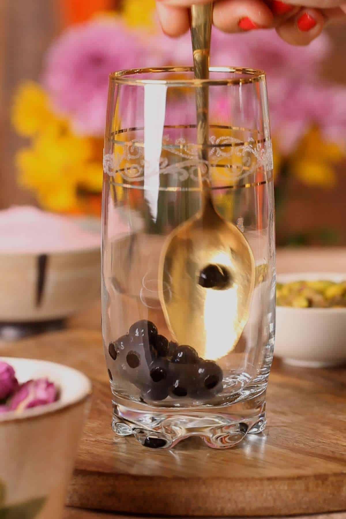 Add boba pearls to a tall glass.