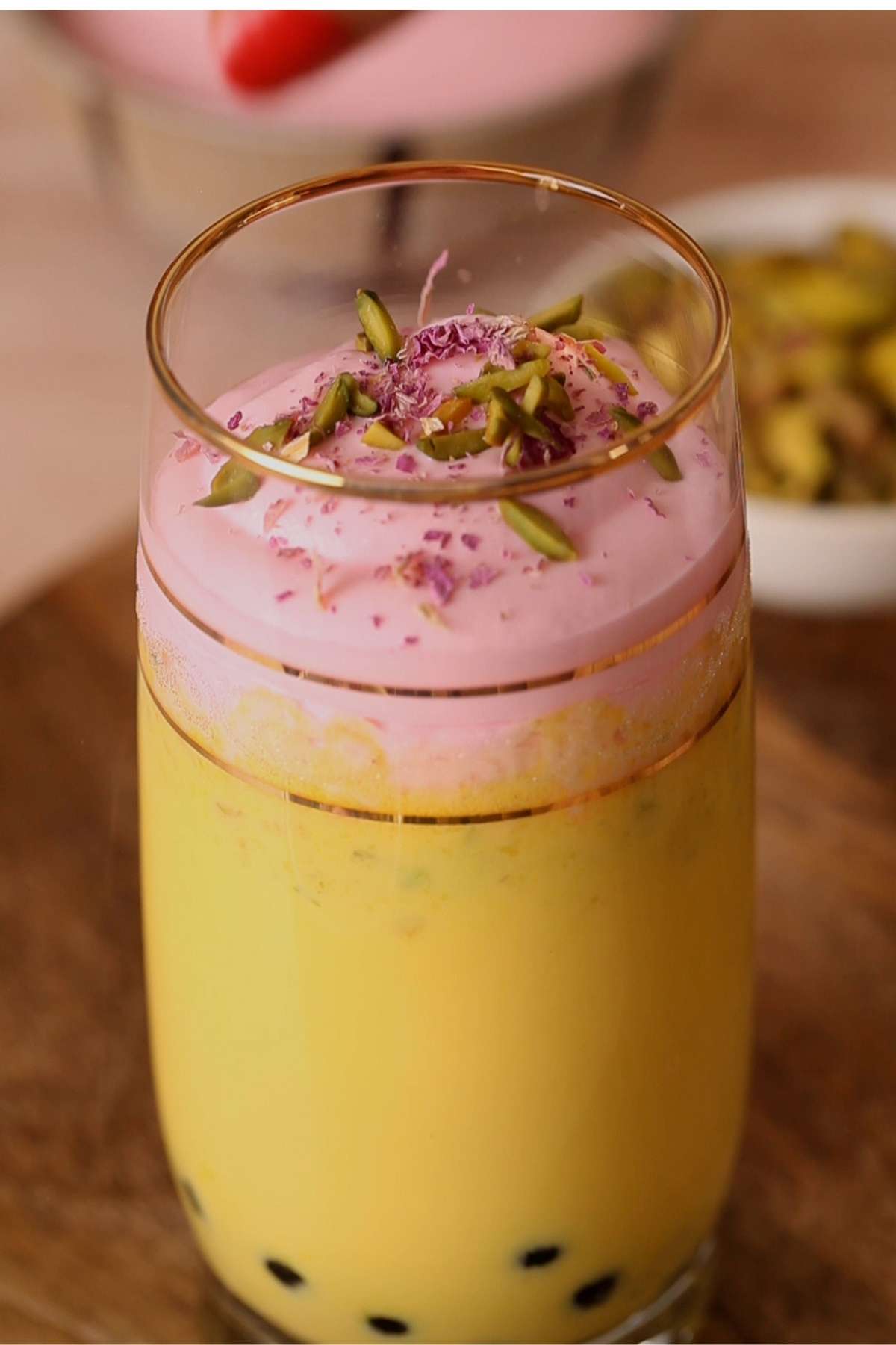 Add rose whipped cream and nuts.