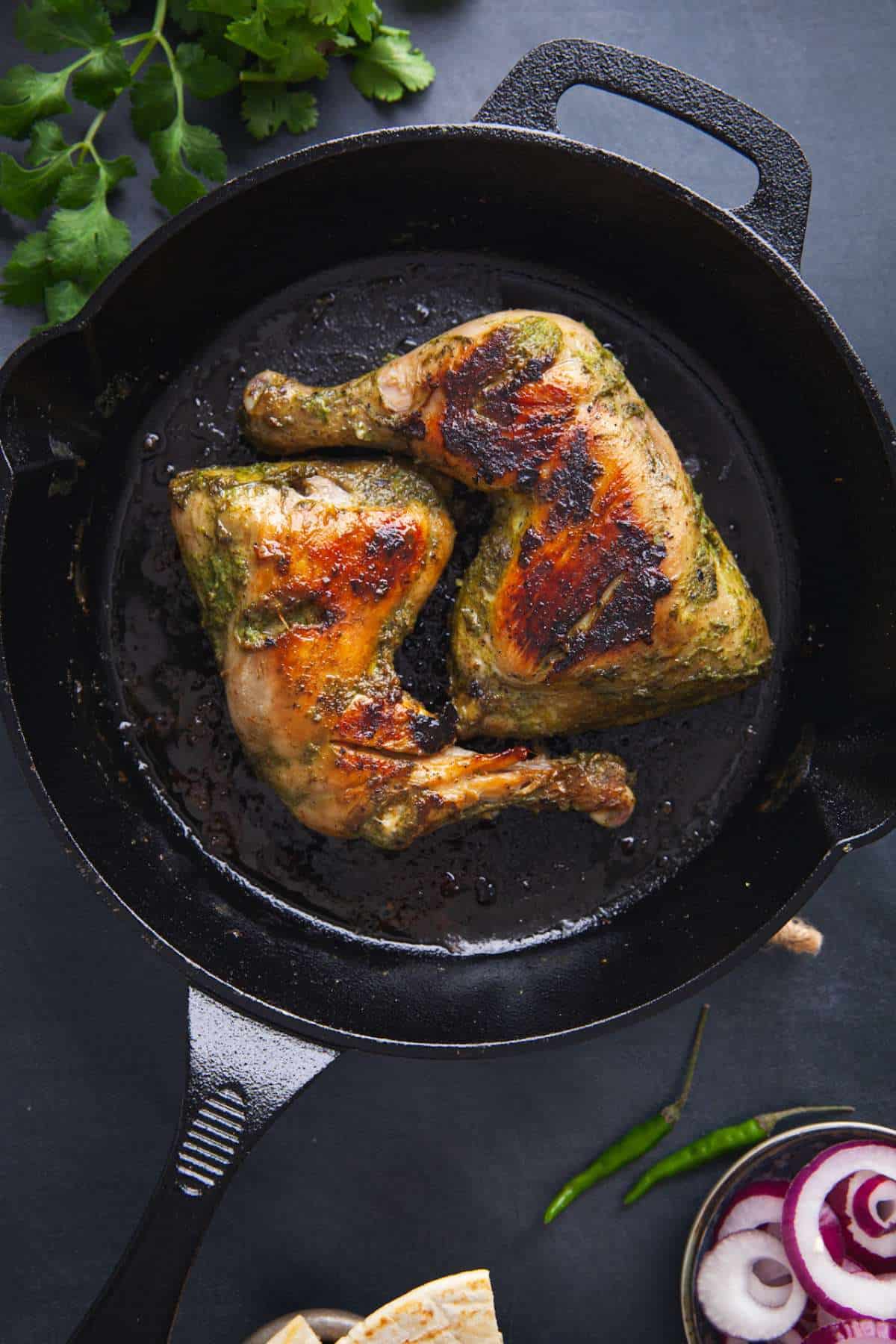 Hariyali Chicken on a cast iron skillet.